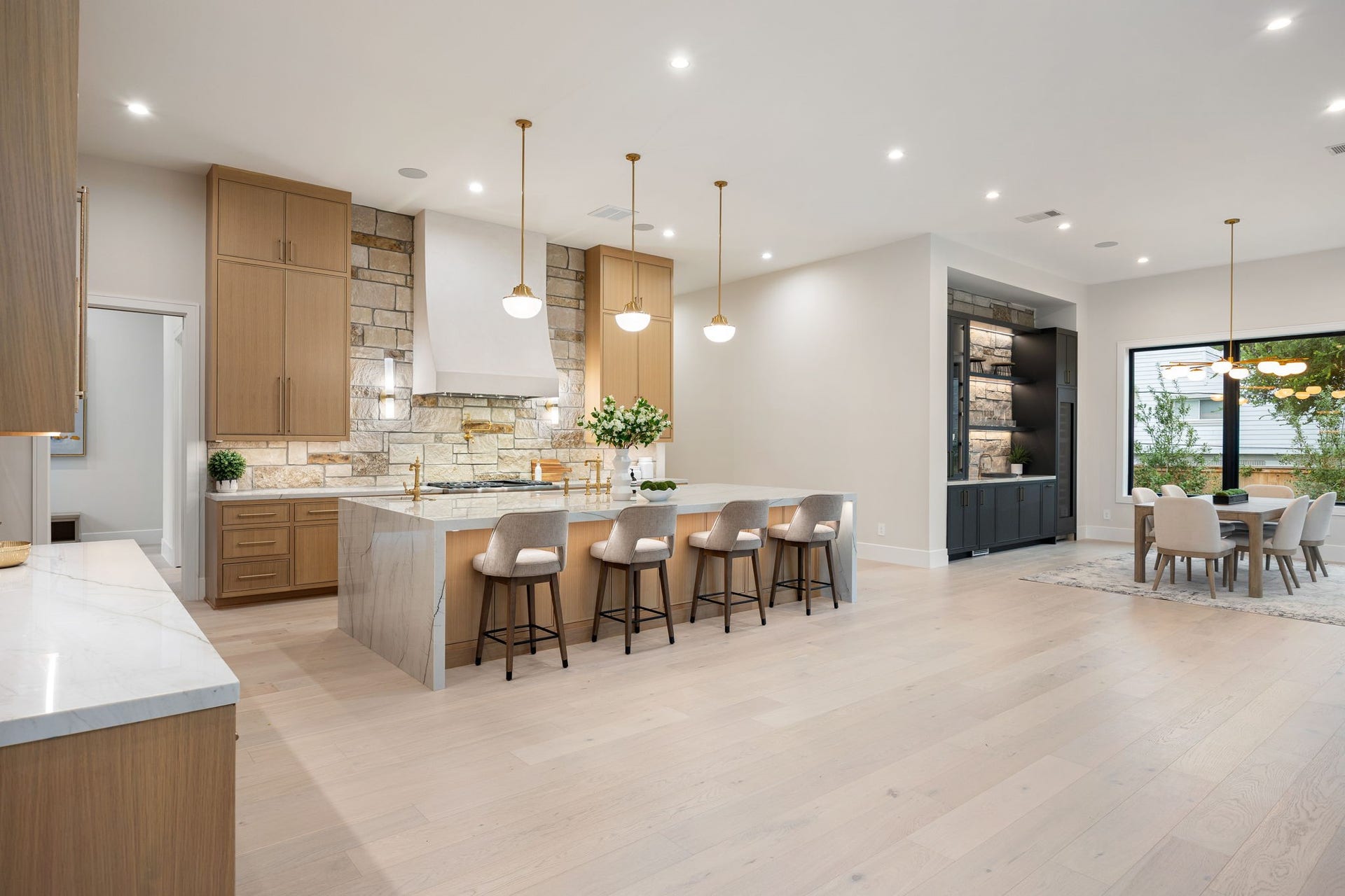 14106 Heatherfield Drive, Houston, TX 77079 This wide-angle view captures the full scale of the kitchen, where thoughtful design meets everyday functionality. The large island anchors the space, complemented by soft lighting and clean architectural lines. The standout element is the balance of openness and defined areas, creating a space that feels both expansive and welcoming for gatherings or quiet moments.