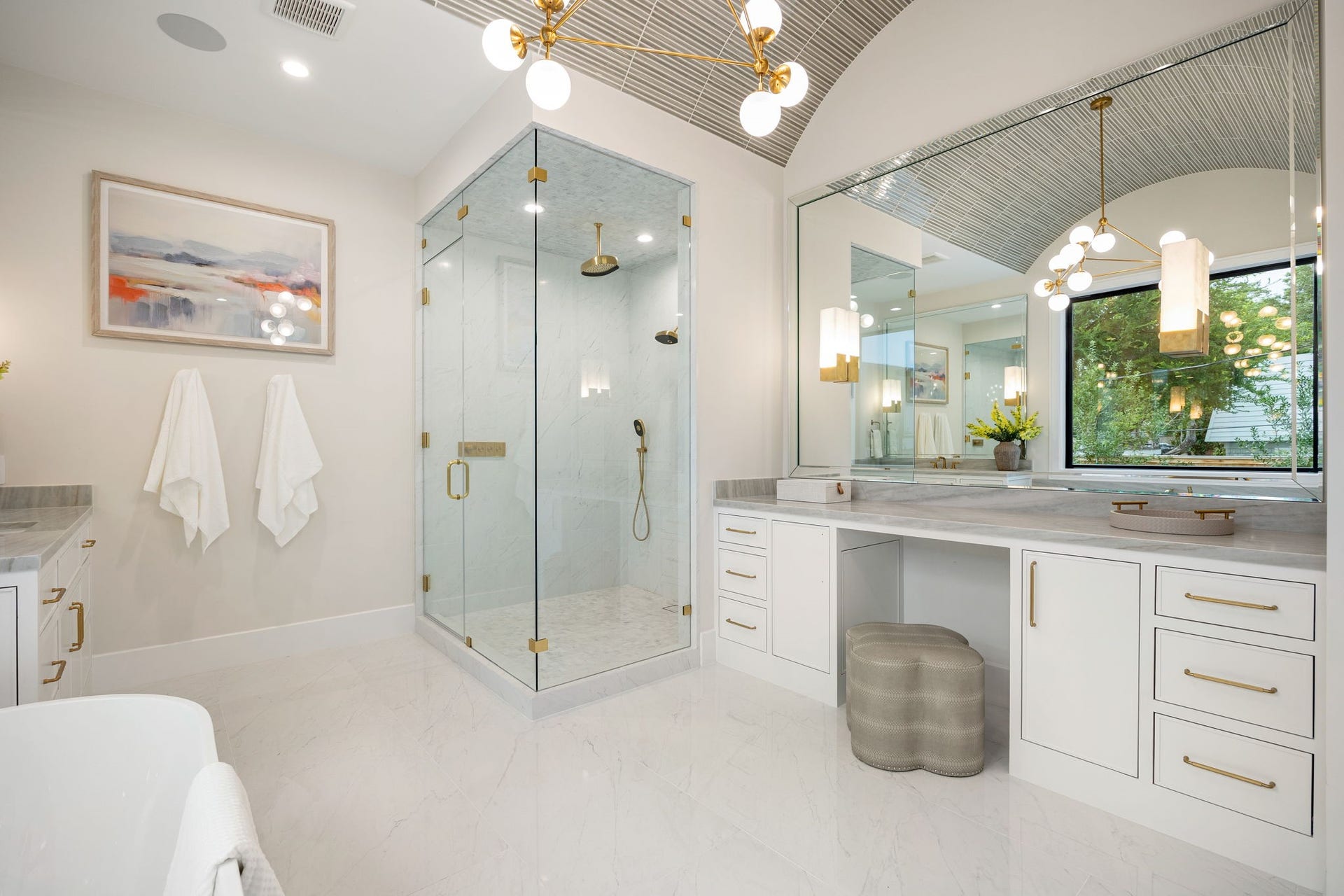 14106 Heatherfield Drive, Houston, TX 77079 This stunning bathroom perspective highlights refined craftsmanship and thoughtful layout, with a seamless blend of materials and textures. The expansive vanity offers ample storage and preparation space. The standout feature is the oversized glass-enclosed shower, designed with clean lines and elegant finishes, creating a spa-inspired experience that enhances both functionality and style.