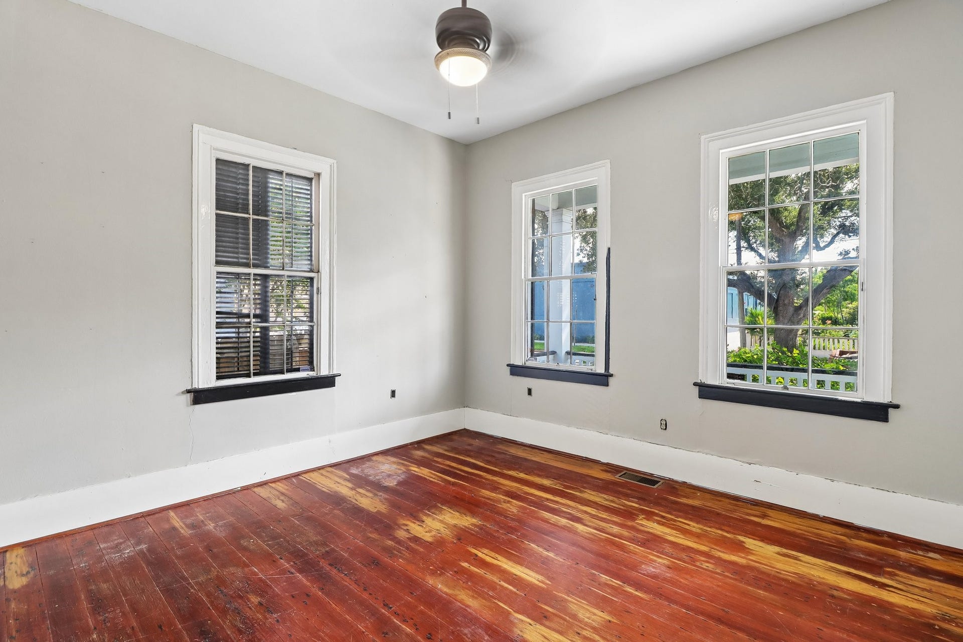 2318 Avenue M, Galveston, TX 77550 Wood flooring, tall windows and detailed trim in one of the homes light-filled interior rooms.