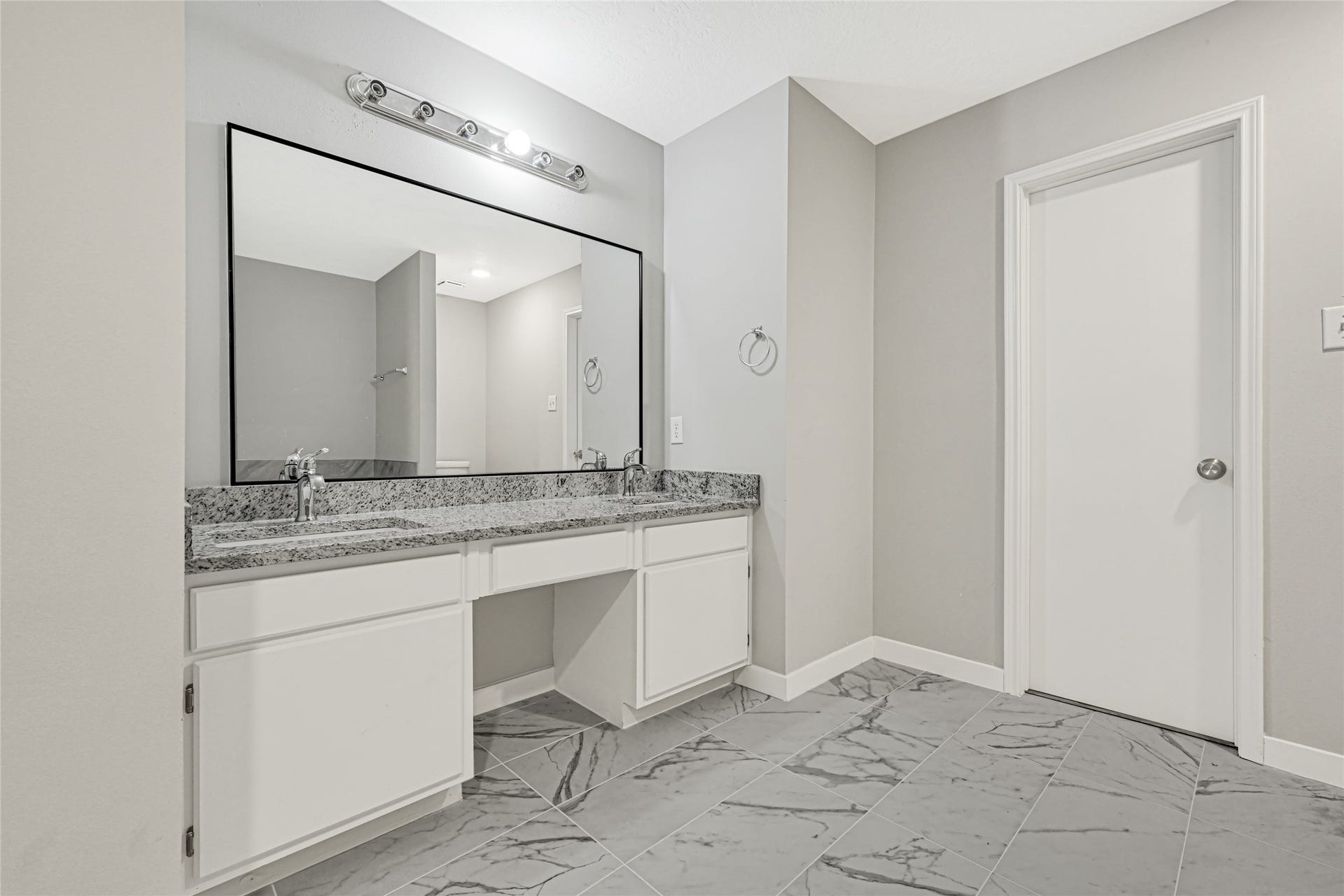 Get ready in this renovated bathroom with dual vanities and brand new granite countertops