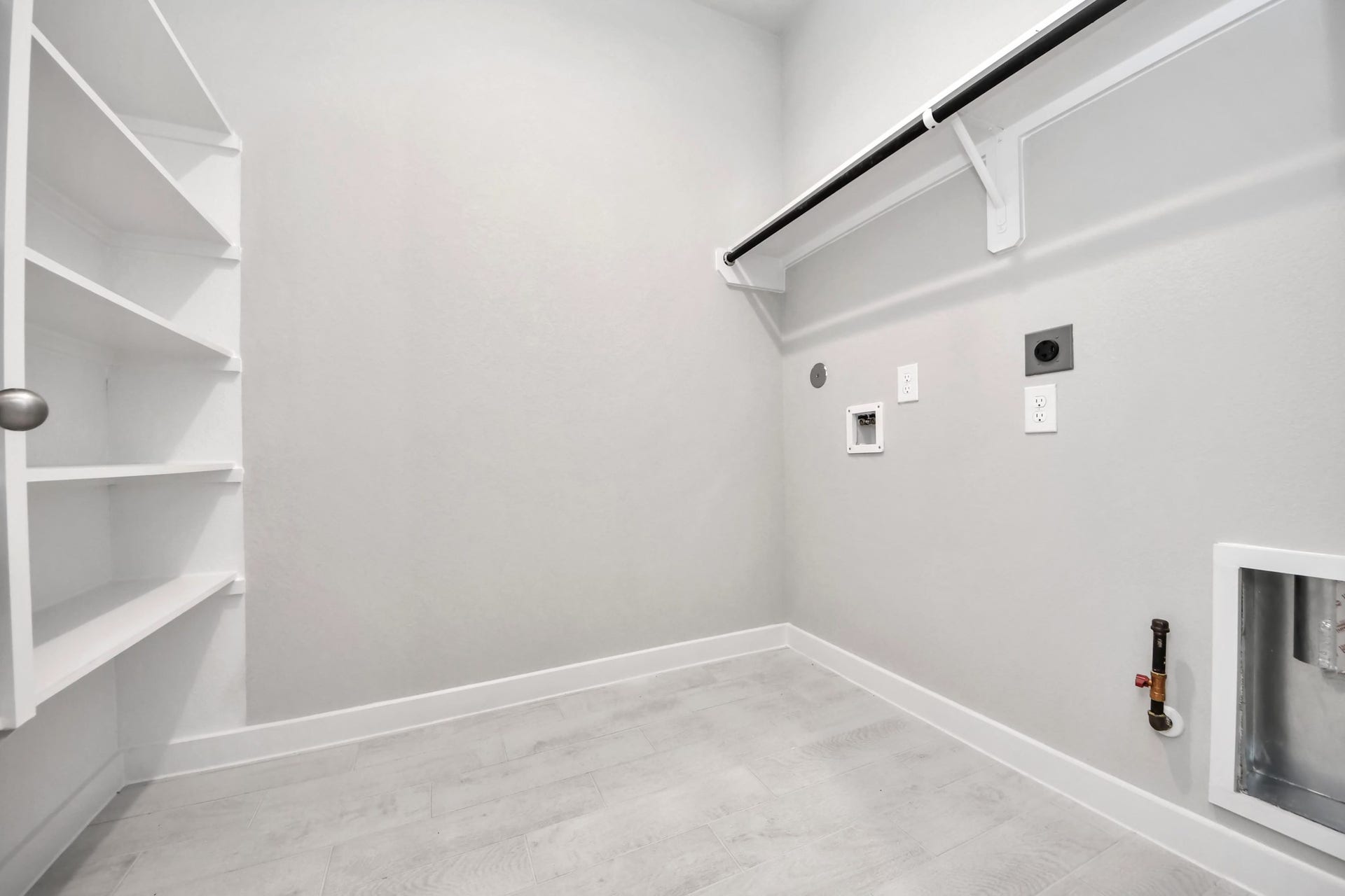 A perfect blend of functionality and comfort. Capture the essence of easy living with a first-floor laundry room, thoughtfully equipped with shelving for effortless organization. Both electric and gas connections available. Sample photo of completed home with similar floor plan. Actual colors and selections may vary.