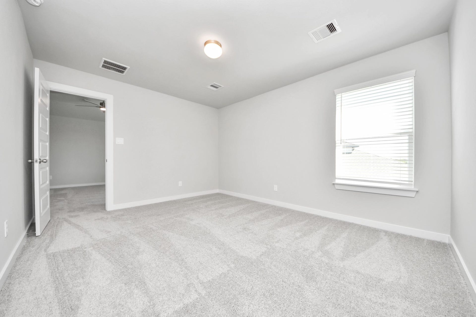 Generously sized secondary bedrooms featuring spacious closets, soft and inviting carpeting underfoot, large windows allowing plenty of natural light, and the added touch of privacy blinds for your personal retreat. Sample photo of completed home with similar floor plan. Actual colors and selections may vary.