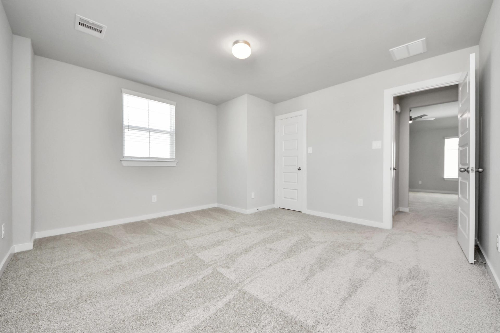 Generously sized secondary bedrooms featuring spacious closets, soft and inviting carpeting underfoot, large windows allowing plenty of natural light, and the added touch of privacy blinds for your personal retreat. Sample photo of completed home with similar floor plan. Actual colors and selections may vary.