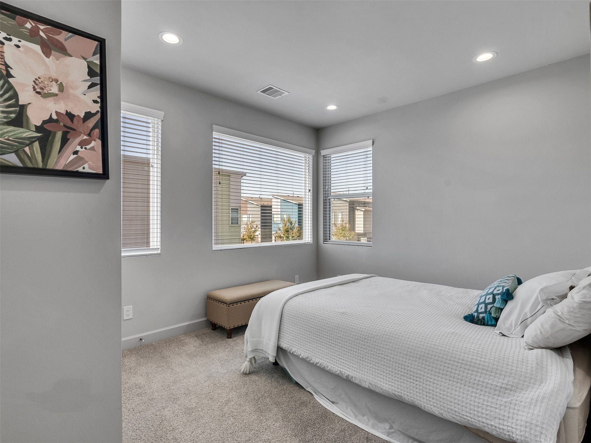 Generous secondary bedroom with great natural light and plush carpeting.