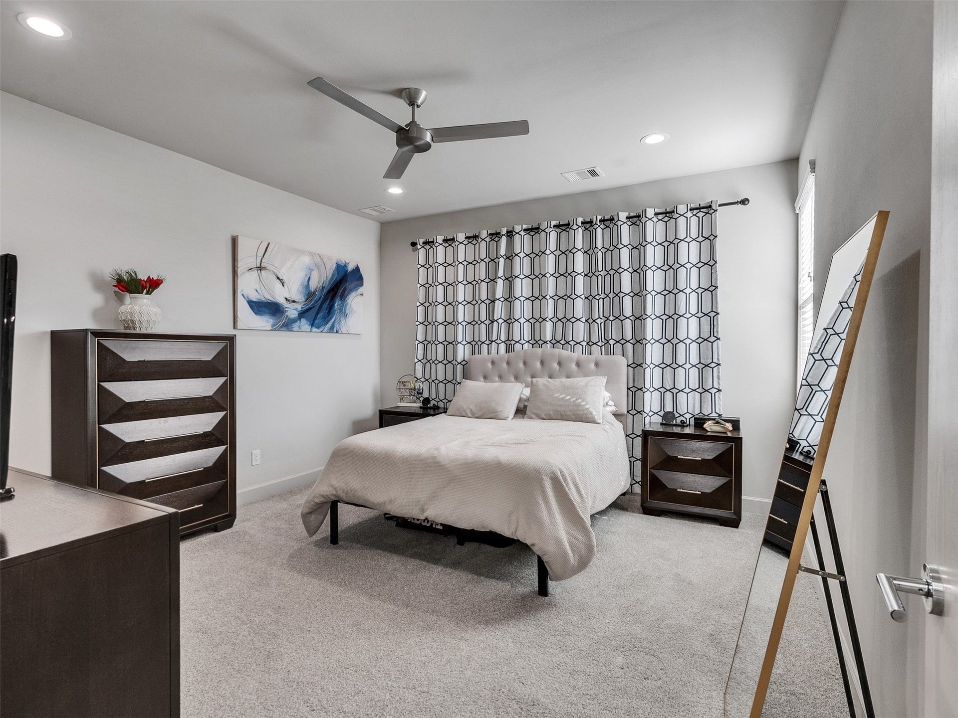 Serene primary retreat with tray ceiling and plenty of room for a king-sized set.