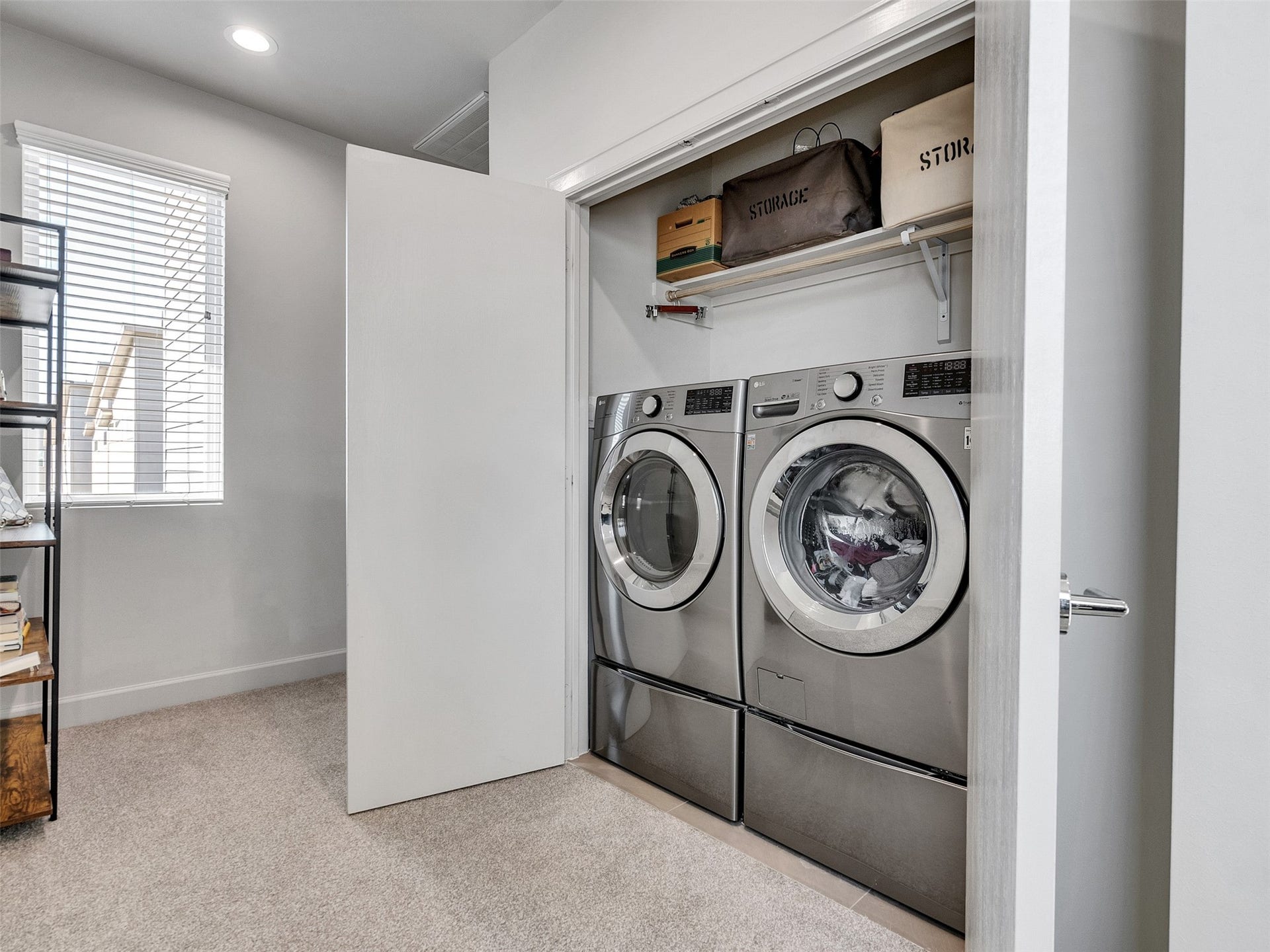 Dedicated laundry space with built-in storage for maximum organization.