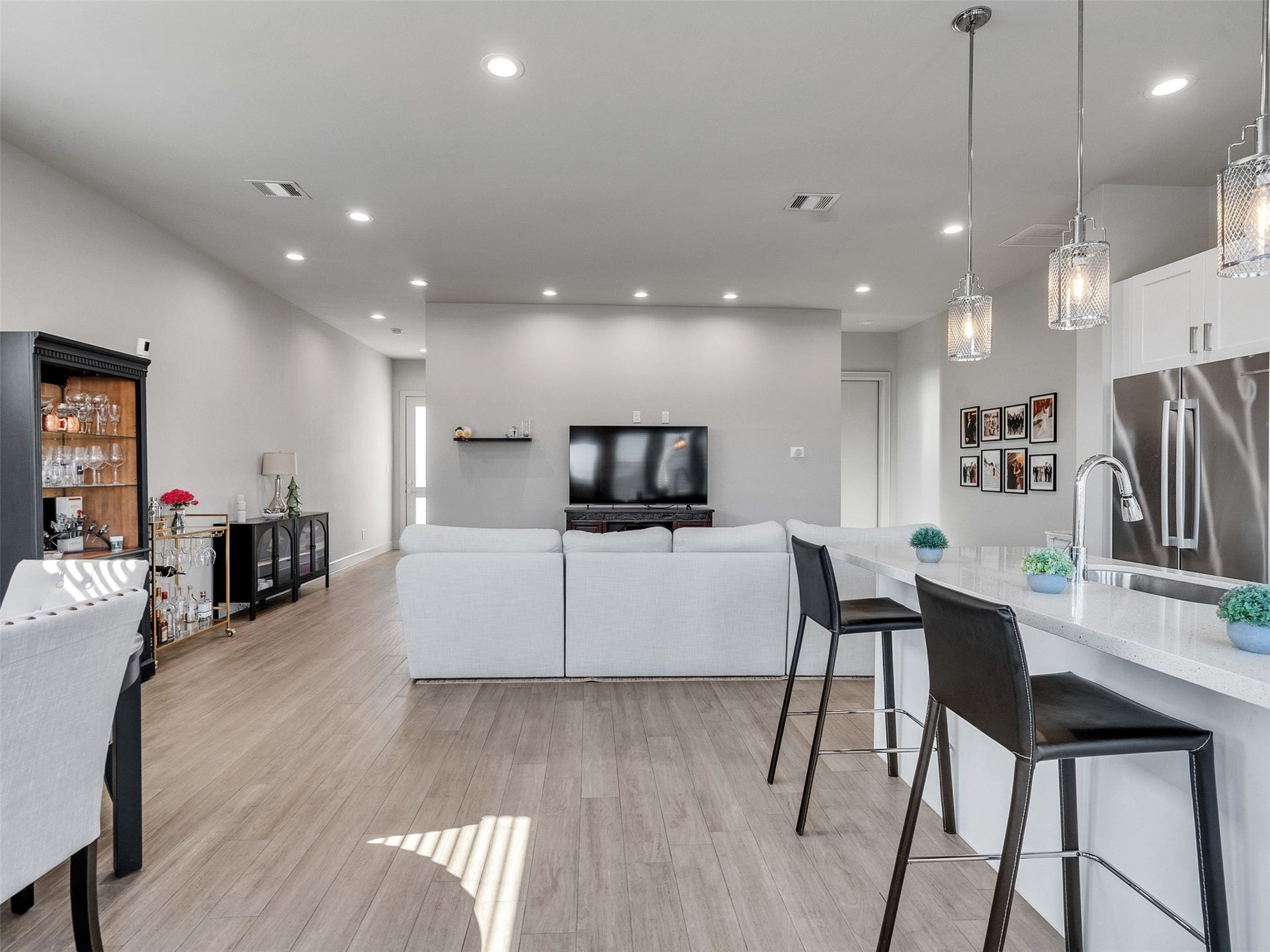 Modern chef's kitchen with a massive granite island and bar seating.