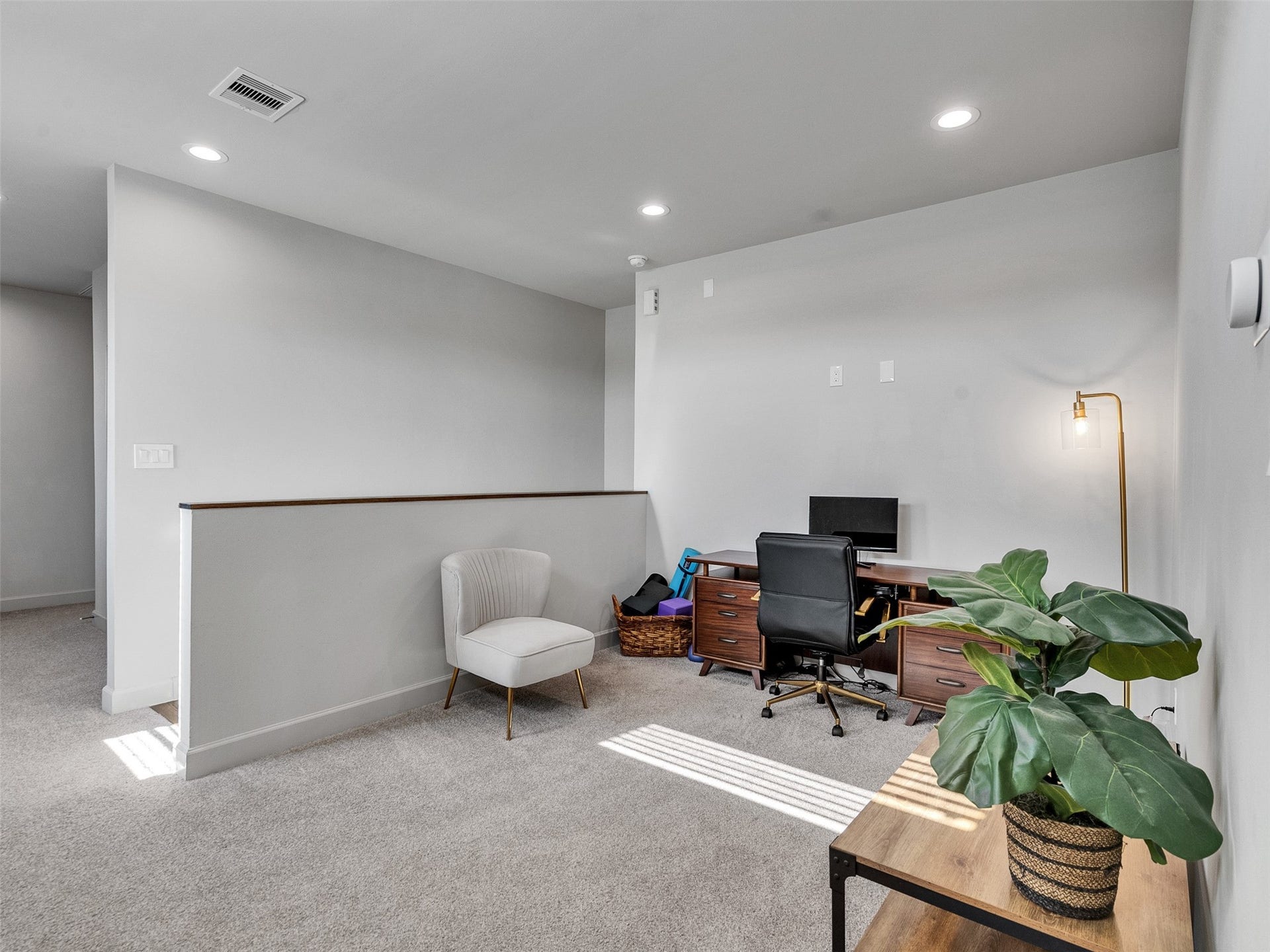 Versatile upstairs loft area, perfect for a home office, gym, or media room.
