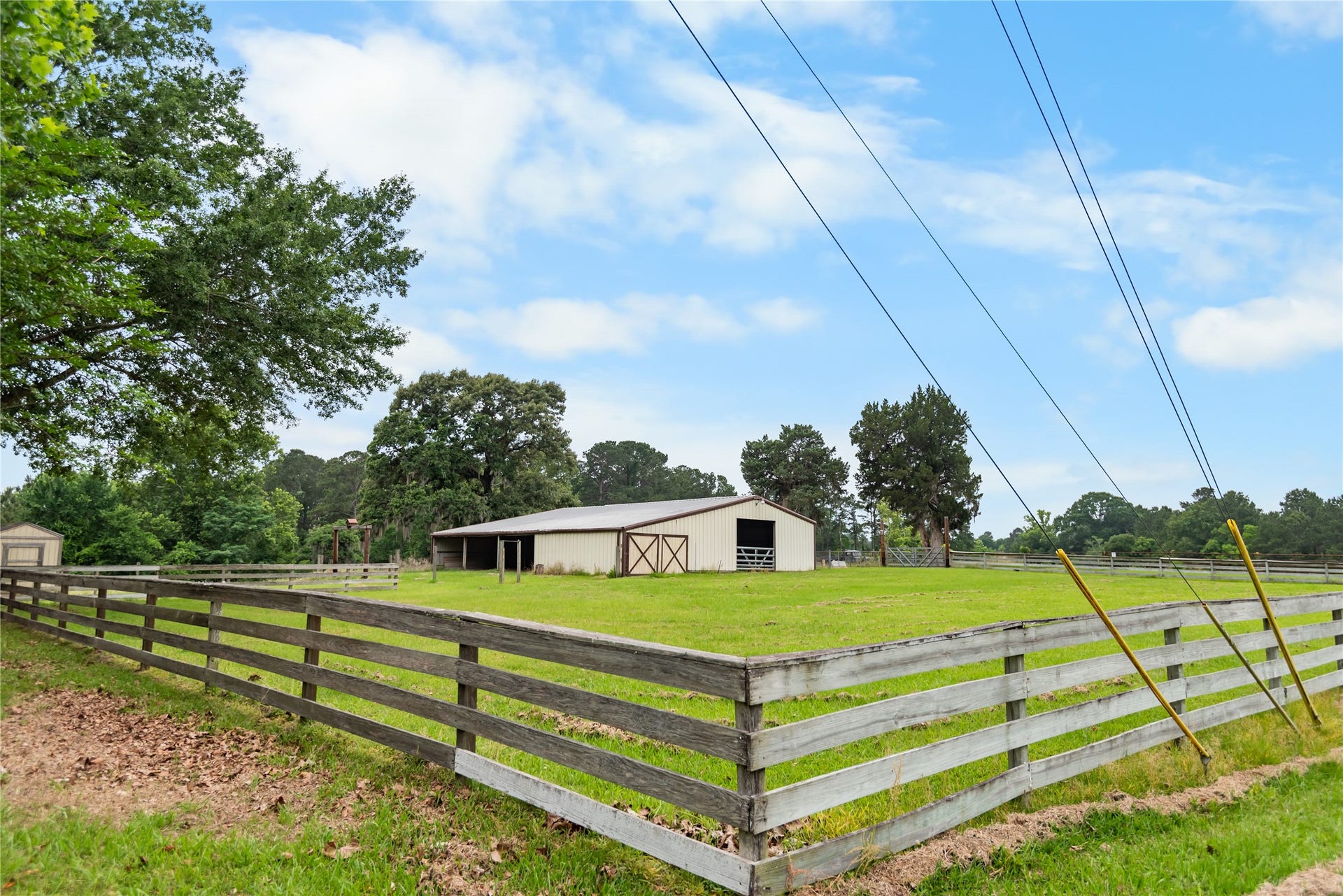 30307 Rickett Lane, Magnolia, TX 77355 Fenced pasture frontage with barn access and plenty of usable land for a variety of uses.