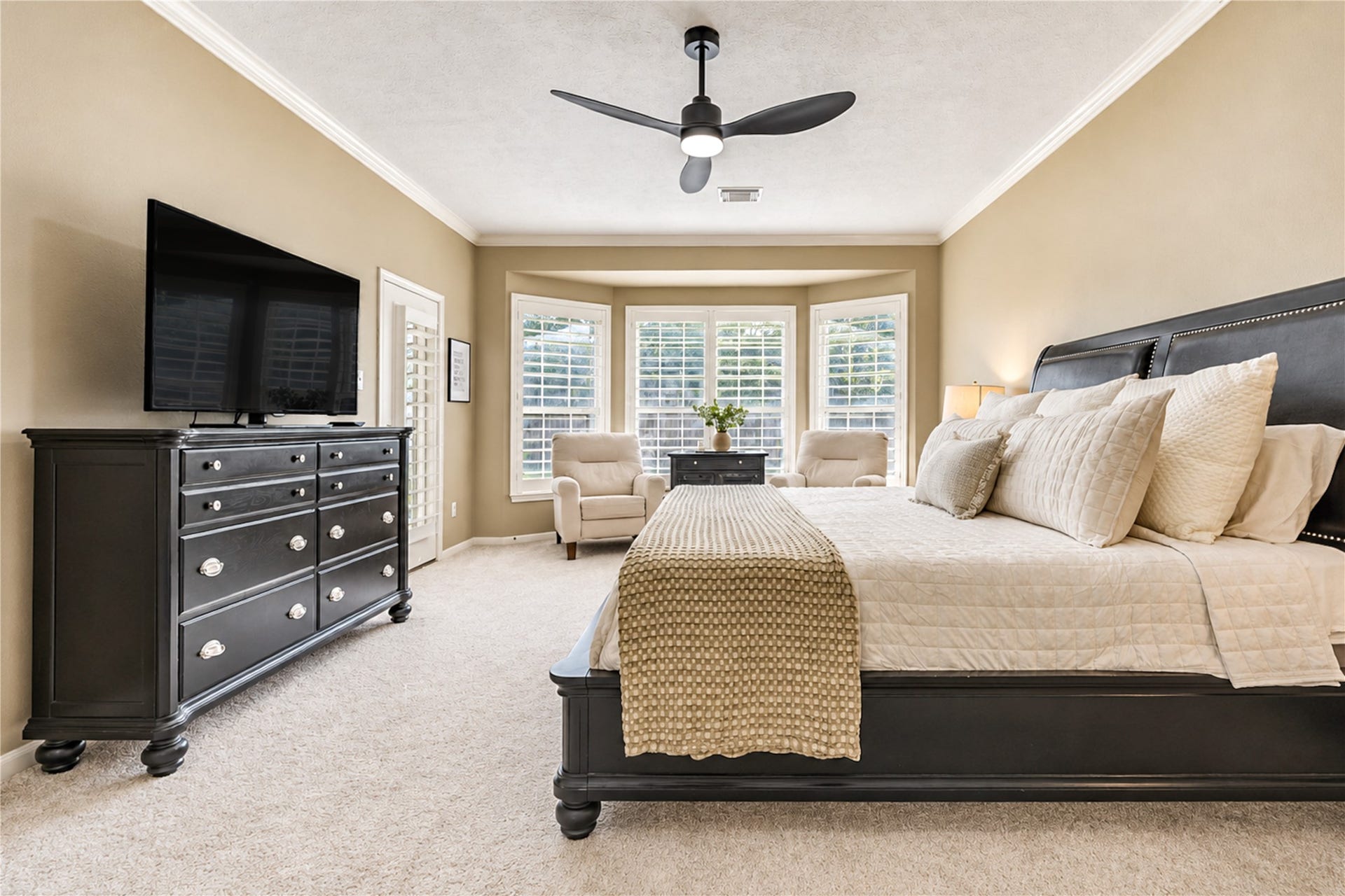23338 Grand Springs Drive, Katy, TX 77494 The huge primary bedroom features a bay window sitting area with plantation shutters and access to the back patio.