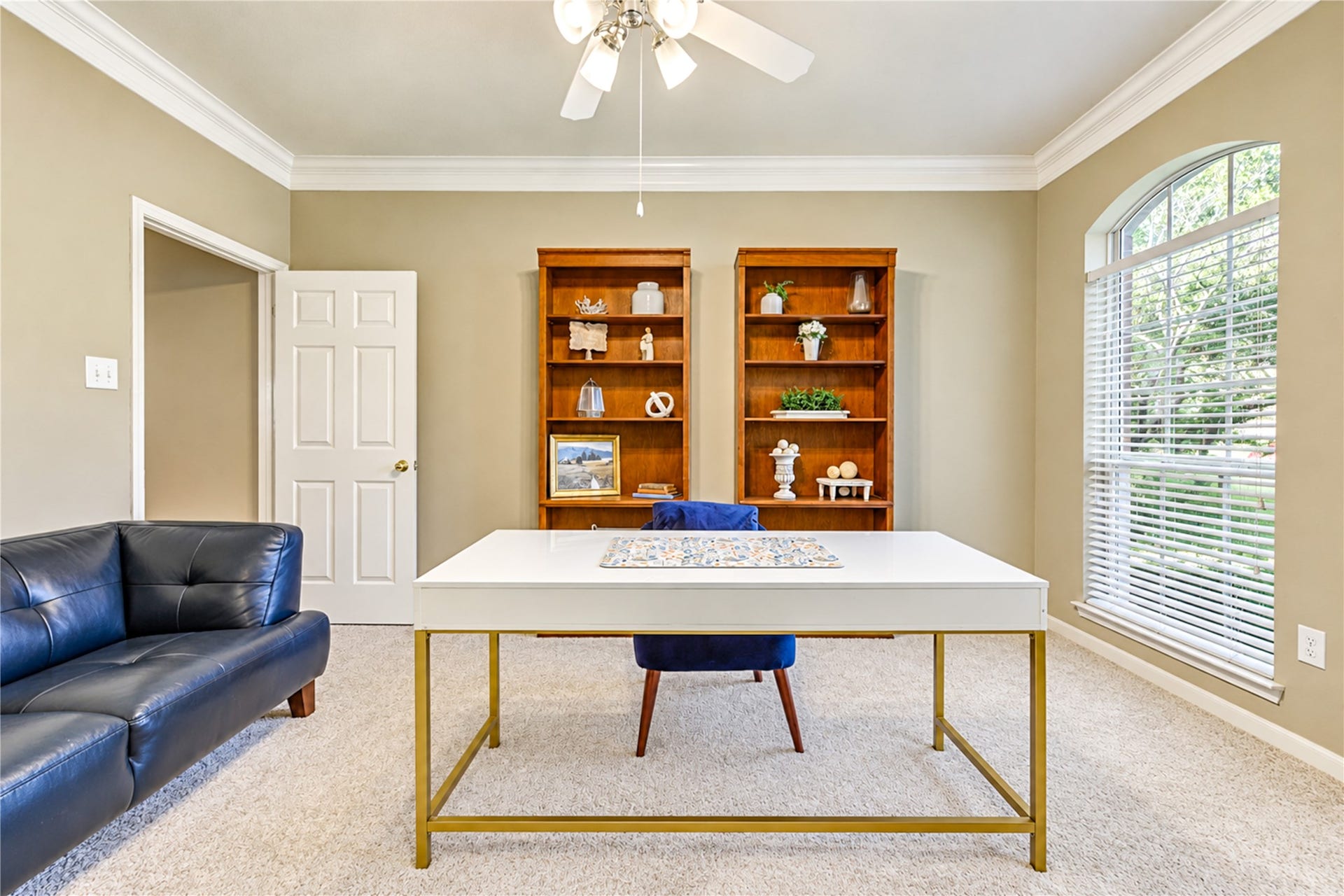 23338 Grand Springs Drive, Katy, TX 77494 To the right of the entry way is a lovely home office or study with crown molding and a ceiling fan. The door at the rear leads to a private hallway to the primary bedroom.