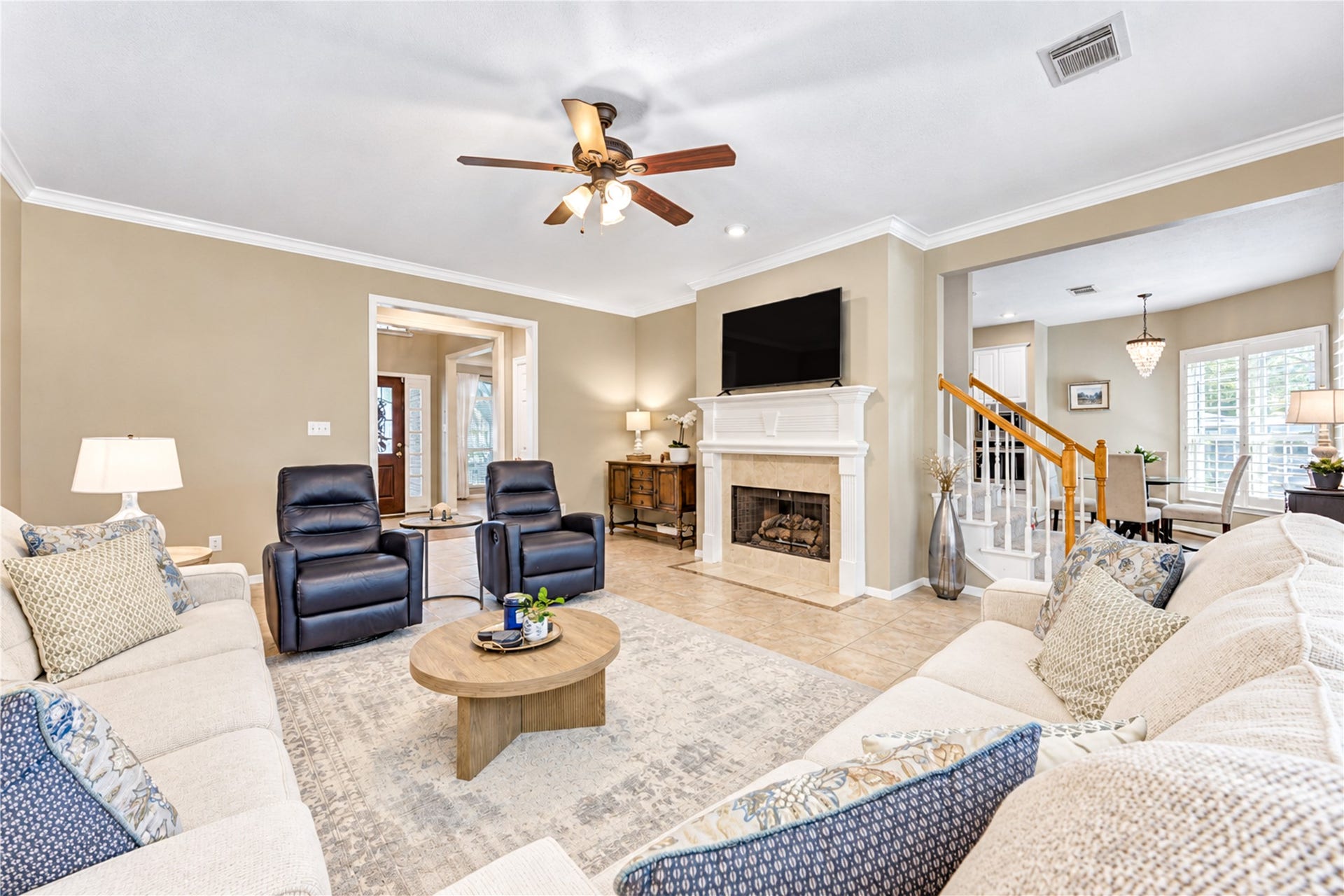 23338 Grand Springs Drive, Katy, TX 77494 The large family room features a fireplace with a custom wood trim mantel, crown molding and ceiling fan. The lovely tile floors flow through the entire first floor living areas.