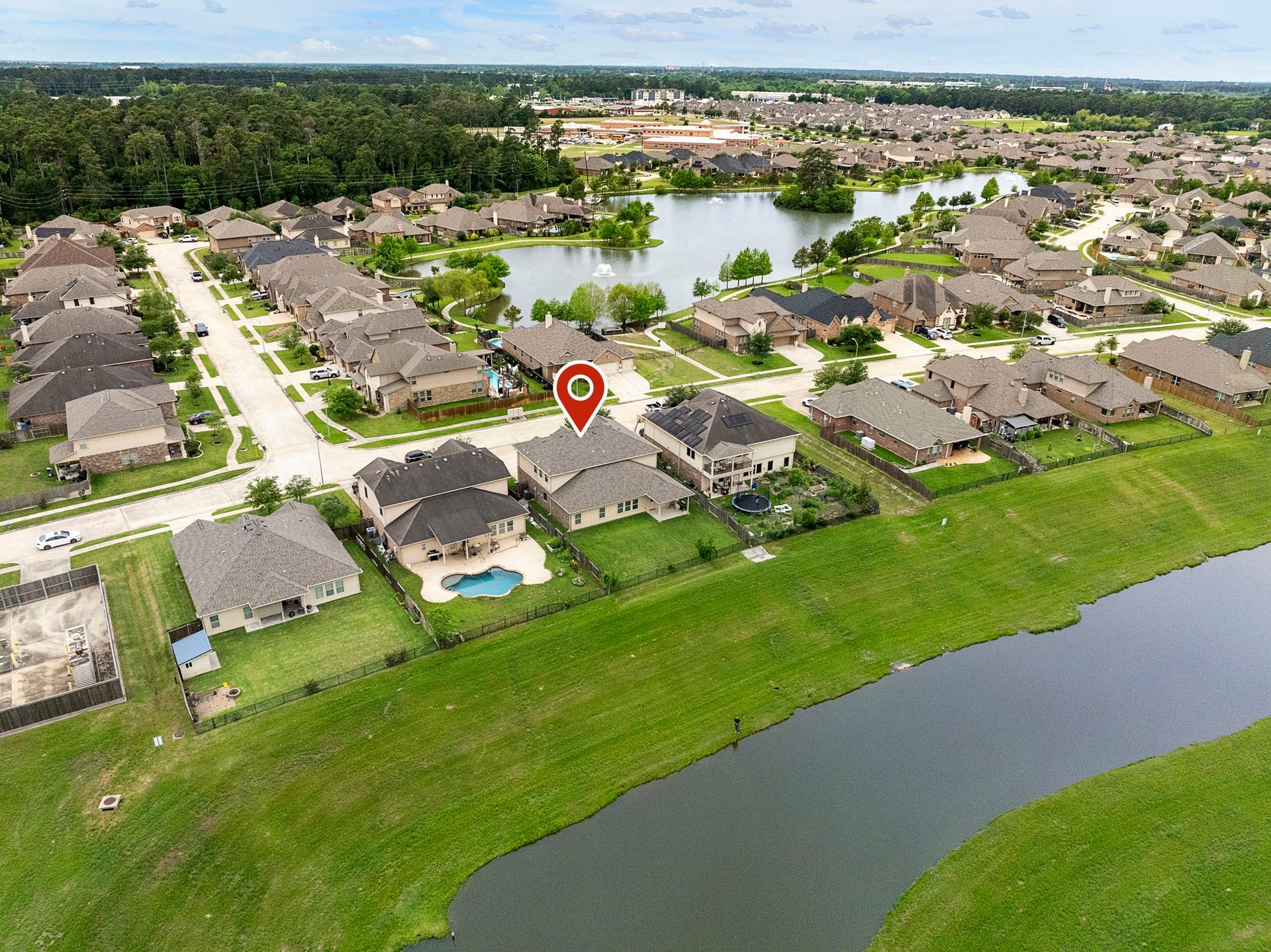 22810 Dale River Road, Tomball, TX 77375 This home privately backs to the water with a thick greenspace barrier in between! Also note the large lake just across the street in front of the house. Unbelievable nature opportunities right at your front AND back doors!