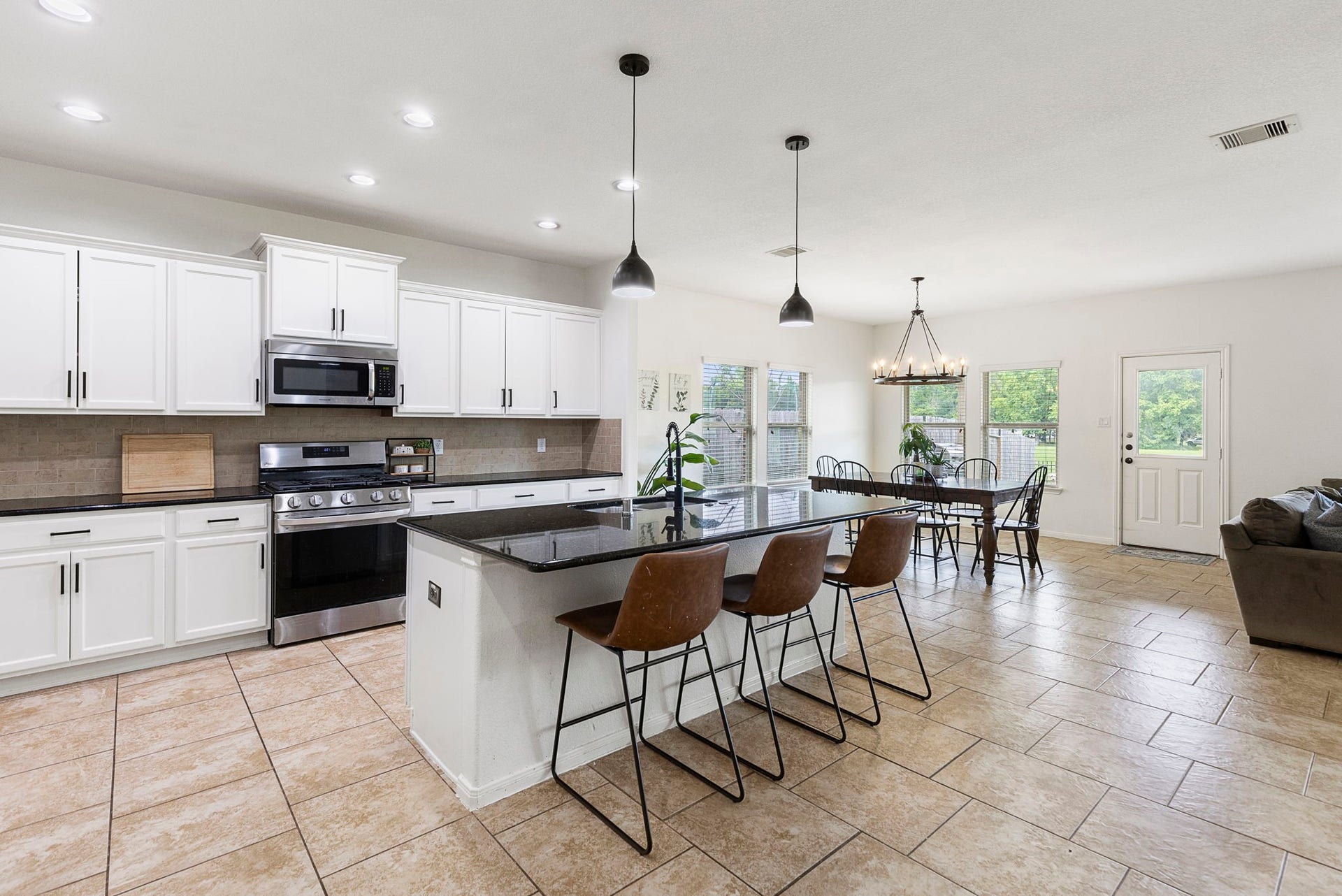 22810 Dale River Road, Tomball, TX 77375 The walls of windows overlooking the backyard provide tons of natural light in this open space.
