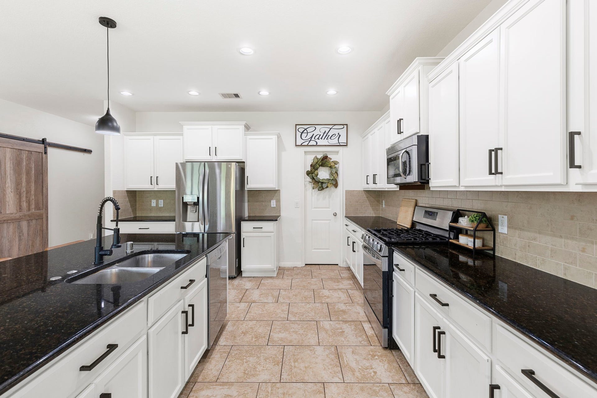 22810 Dale River Road, Tomball, TX 77375 This kitchen features stainless appliances and large walk-in pantry.