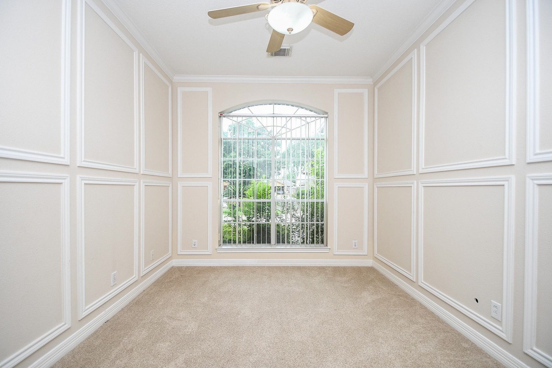 Sunlit, inviting room with stylish wall paneling.