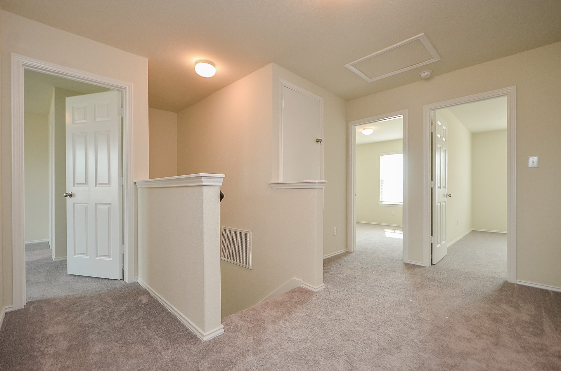 Primary bedroom to the left; secondary bedrooms straight ahead; full bath to right.