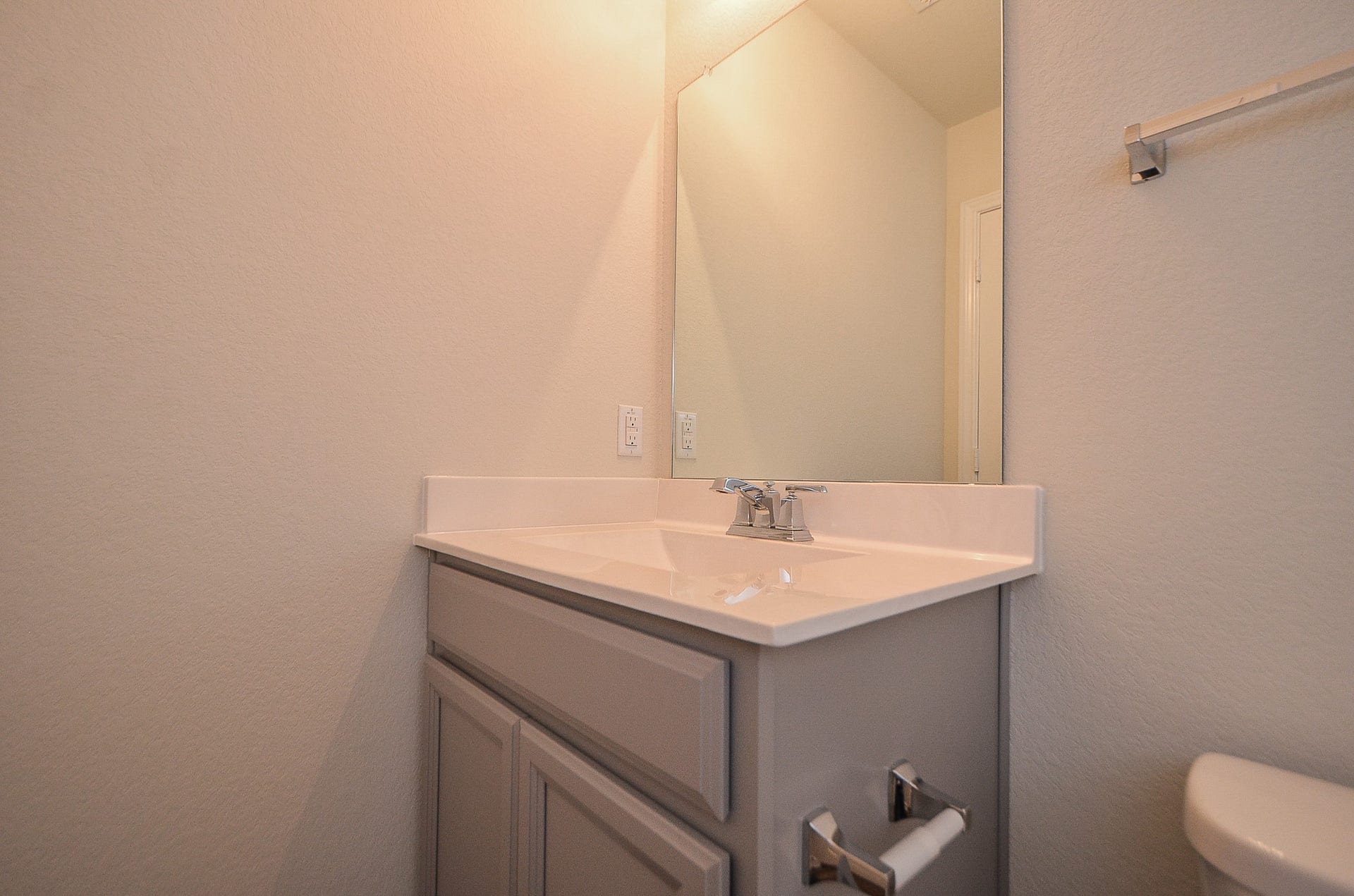 Hall bath with vanity & mirror.
