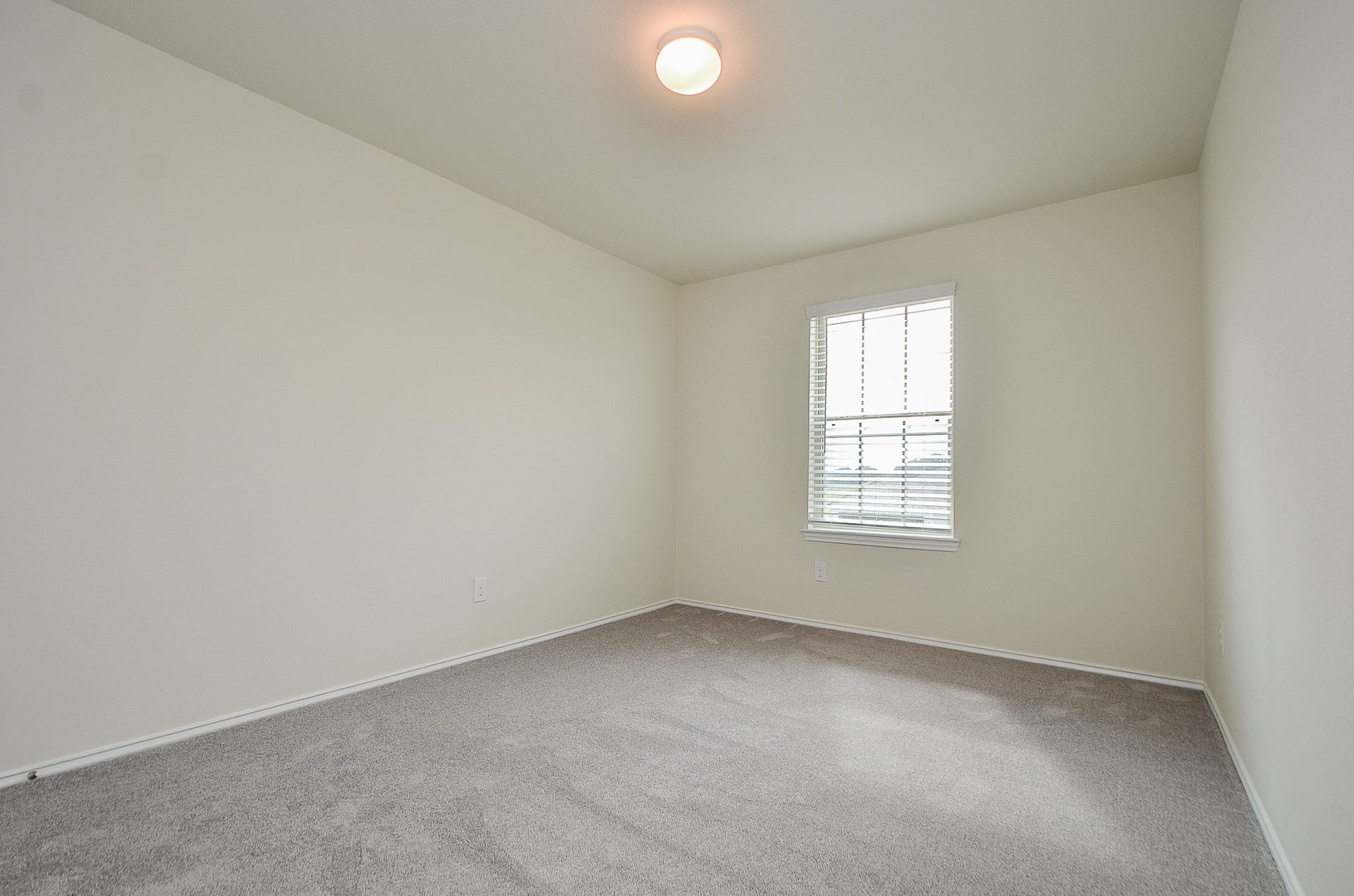 Bedroom 3 features carpet, neutral paint & window treatments.