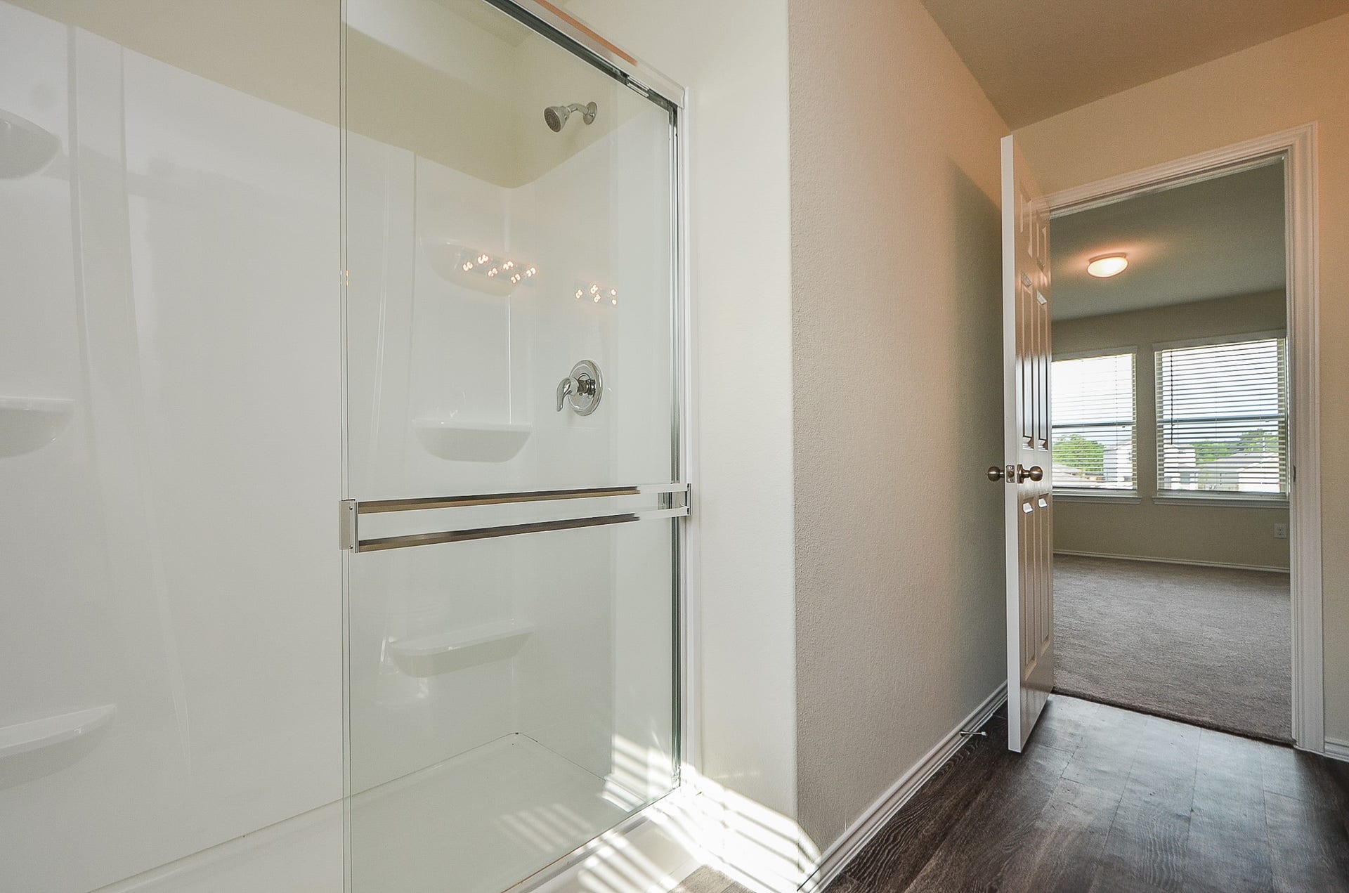 Primary bath features a room surround shower stall (no cleaning grout!).