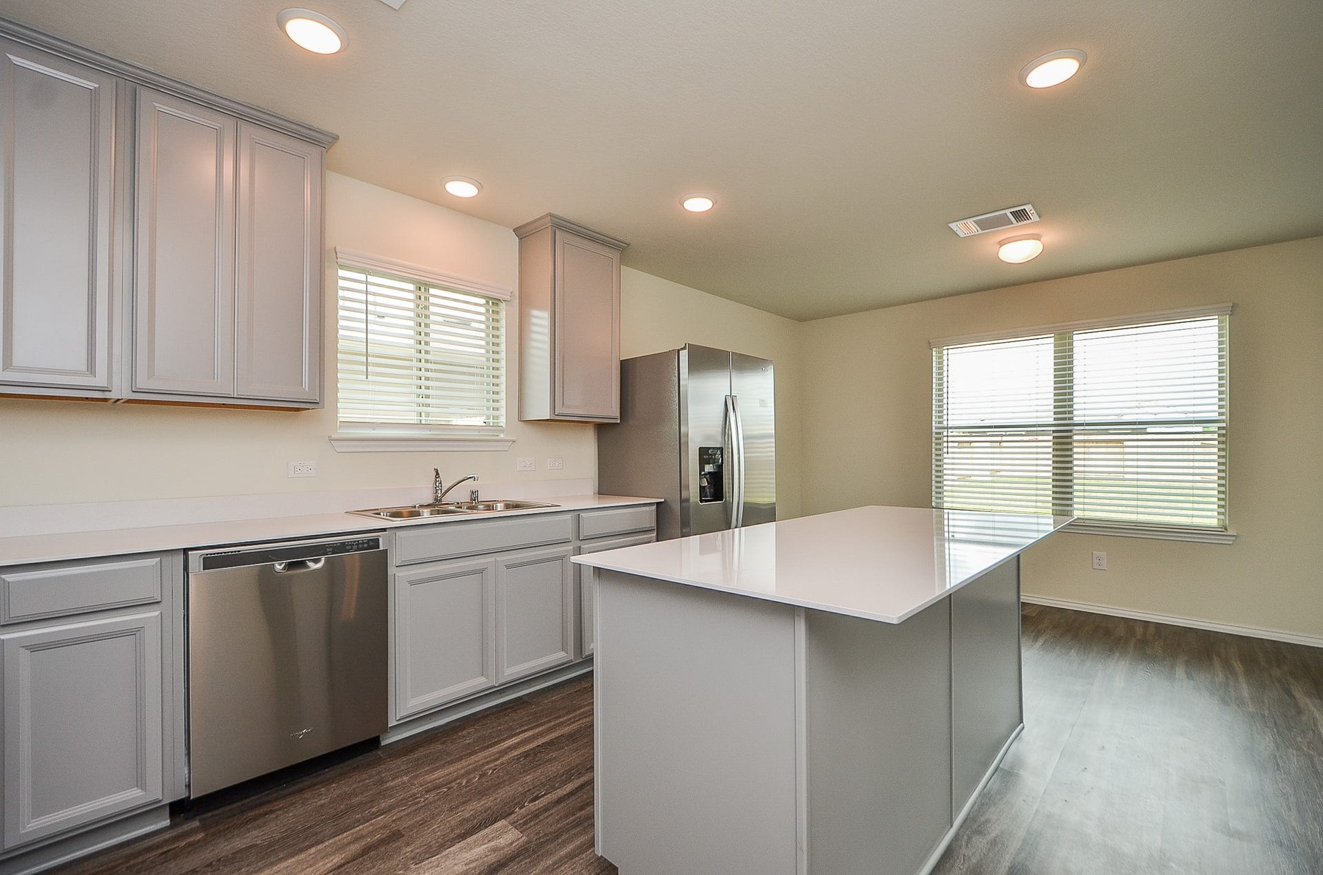 This island kitchen features contemporary granite countertops & 4" backsplash.