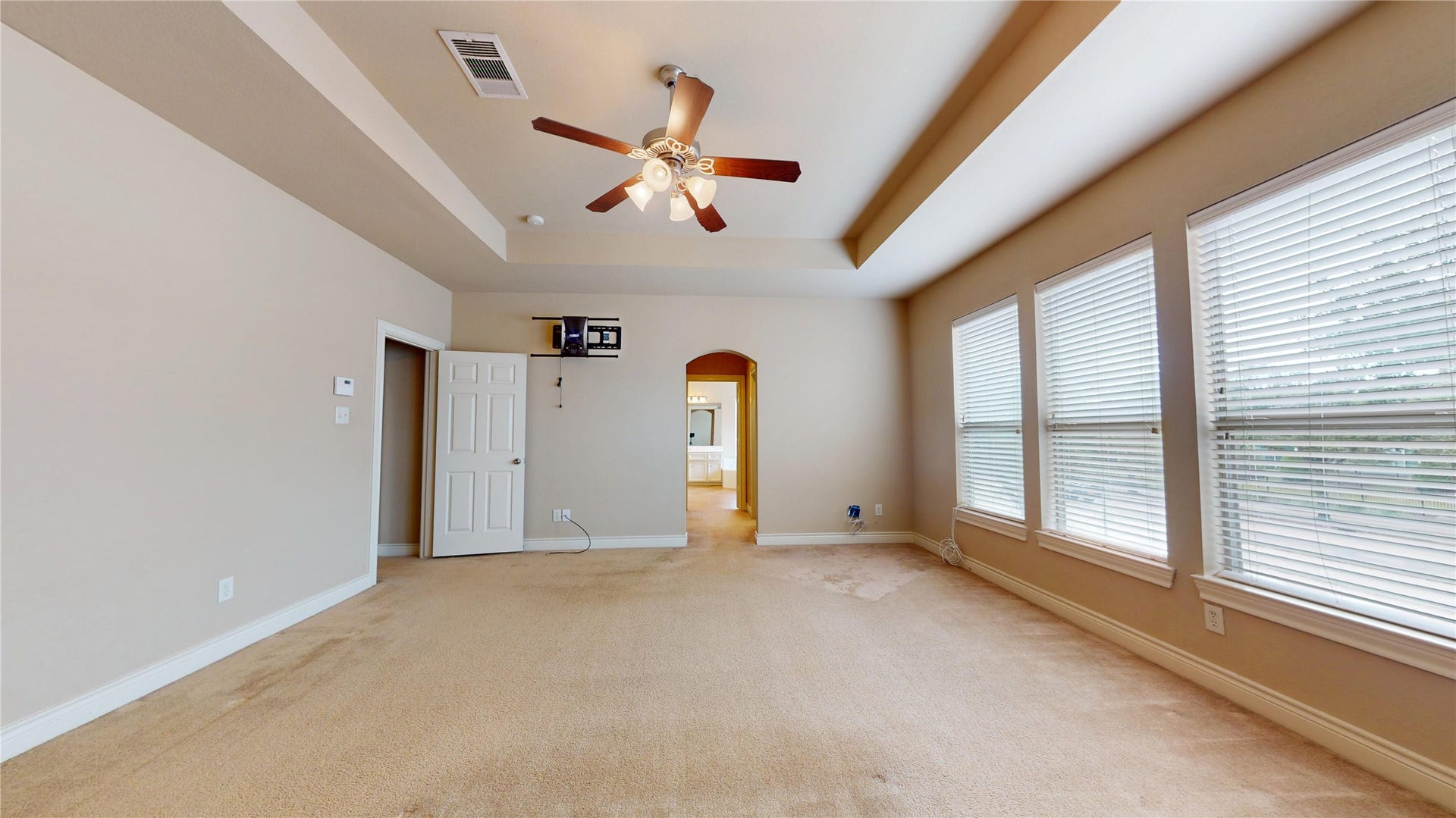 3502 Urban Woods Trail, Houston, TX 77008 Primary bedroom with its coffered ceiling and wall of windows...