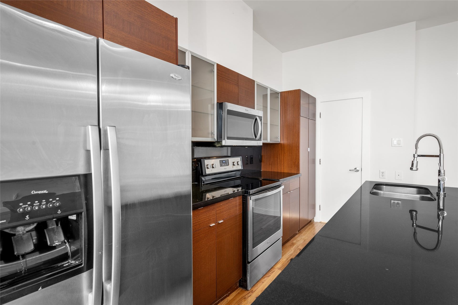 5712 Winsome Lane, #5, Houston, TX 77057 Well-appointed kitchen featuring stainless steel appliances, a spacious island with a sink, and plenty of counter space, perfect for cooking and entertaining.