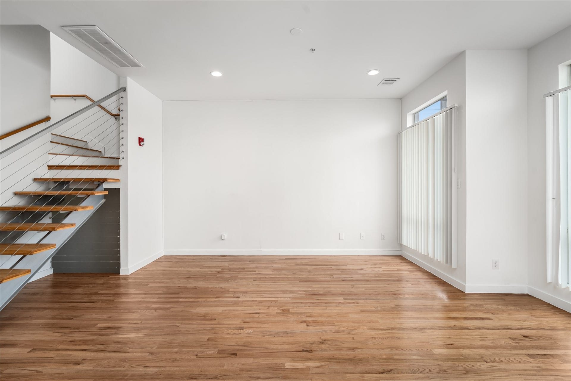 5712 Winsome Lane, #5, Houston, TX 77057 Bright and airy living area with expansive floor-to-ceiling windows, allowing natural light to fill the space and create a welcoming, open ambiance.