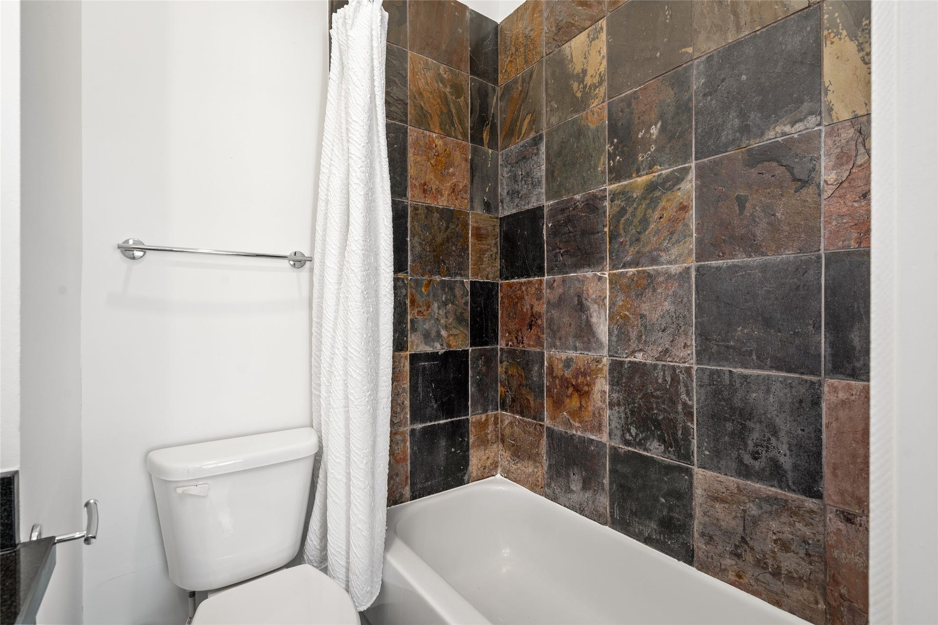 5712 Winsome Lane, #5, Houston, TX 77057 Elegant primary bathroom featuring a tub/shower combo with gorgeous tilework, blending style and functionality