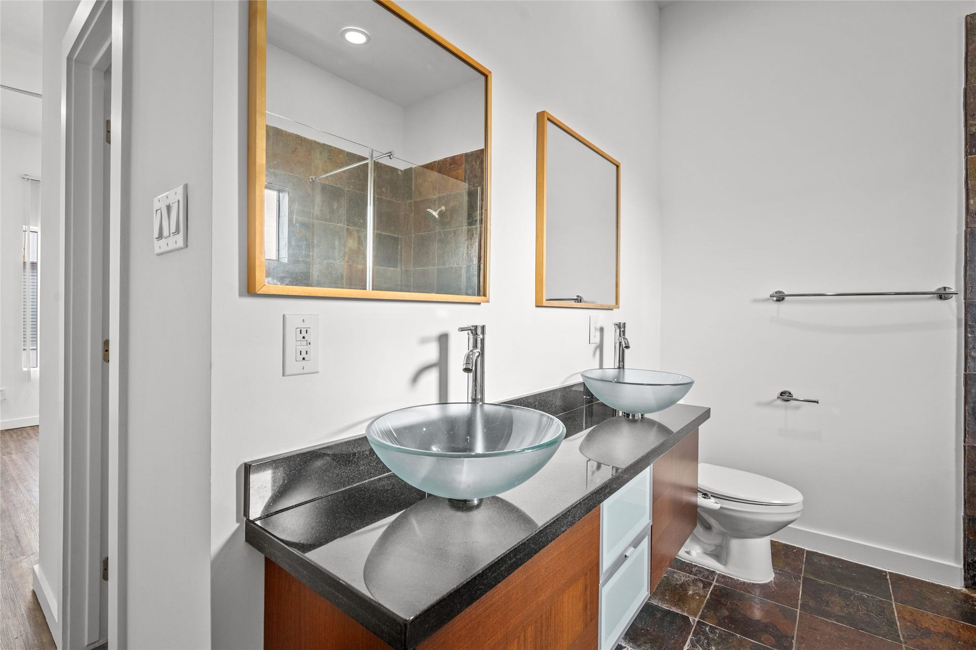 5712 Winsome Lane, #5, Houston, TX 77057 Luxurious primary bathroom featuring dual vessel sinks and a lavish shower, combining elegance with modern comfort.