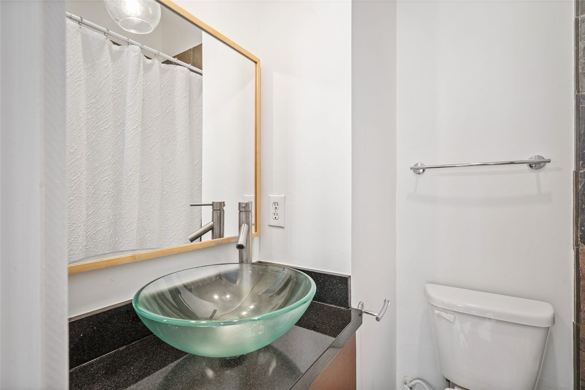 5712 Winsome Lane, #5, Houston, TX 77057 Stylish secondary bathroom featuring a unique glass sink, adding a modern touch and creating an elegant, contemporary look.
