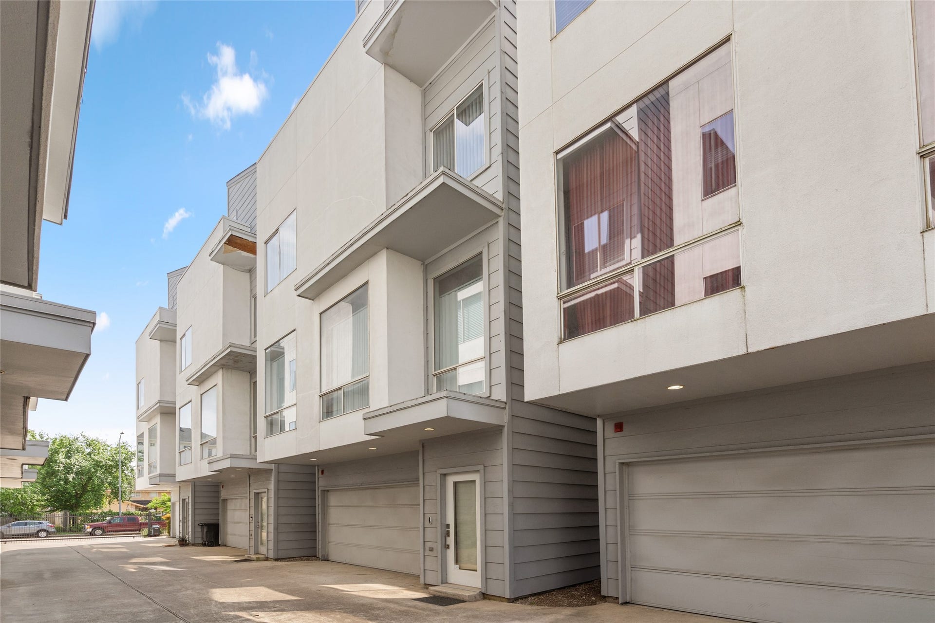 5712 Winsome Lane, #5, Houston, TX 77057 Modern multi-level townhome with a sleek exterior design, featuring large windows for natural light and a spacious two-car garage. Located in a secure and well-maintained community with easy access to nearby amenities