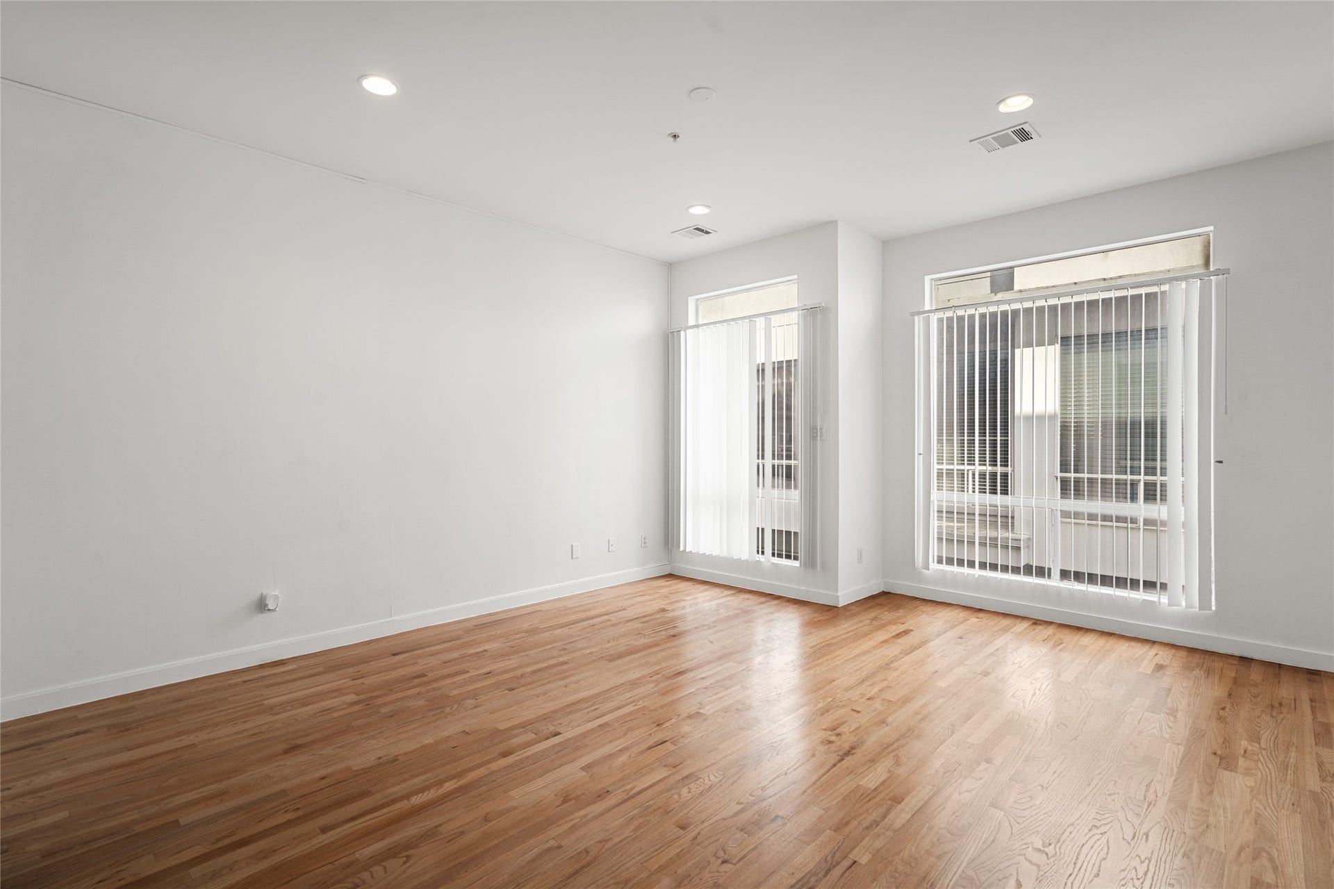 5712 Winsome Lane, #5, Houston, TX 77057 Spacious, well-lit, and airy living area enhanced by wide, floor-to-ceiling windows that flood the space with natural light, creating an inviting and open atmosphere.