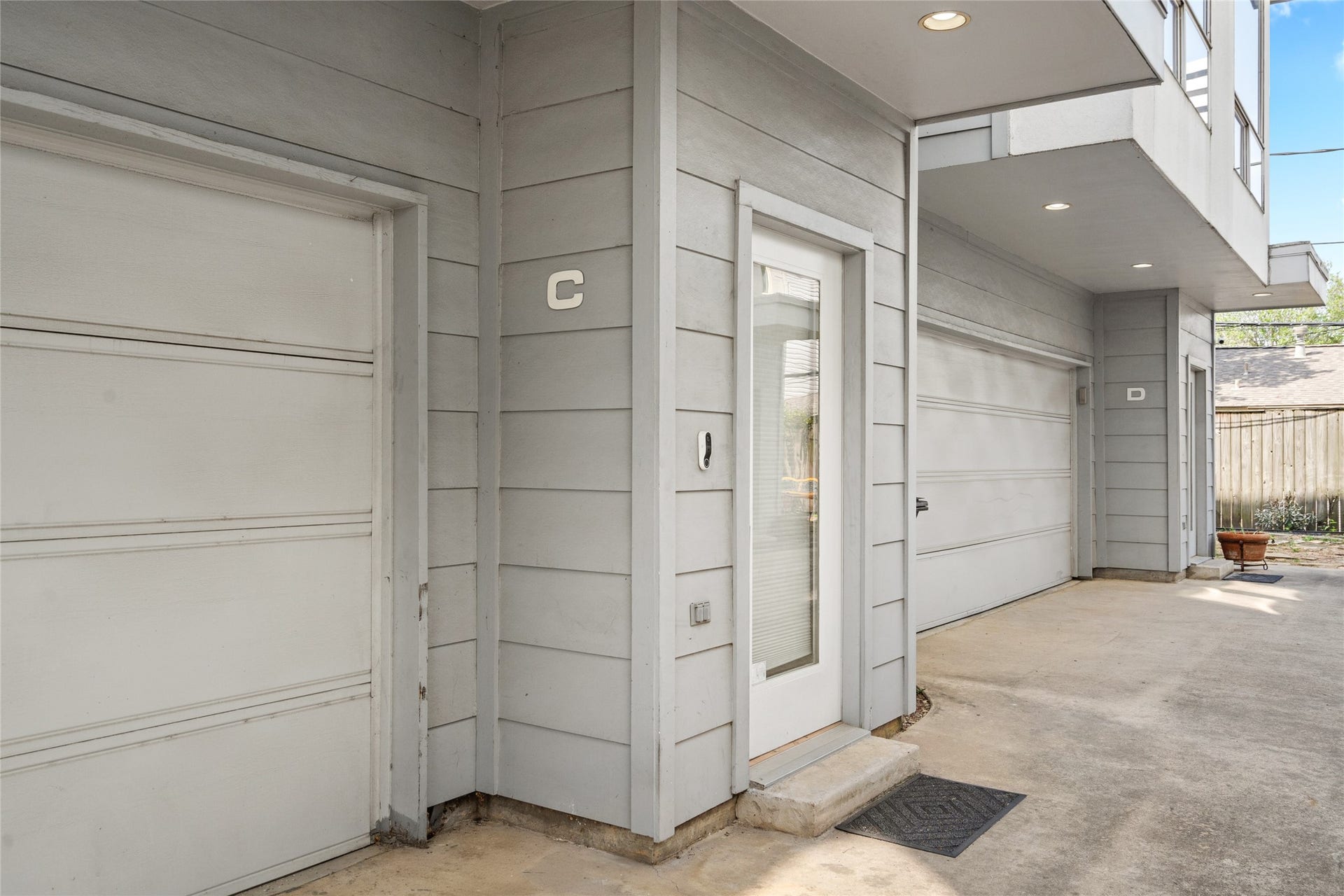 5712 Winsome Lane, #5, Houston, TX 77057 Private entryway with a modern glass-paneled door, complemented by a covered entrance for added convenience. The attached two-car garage provides secure parking and additional storage space.