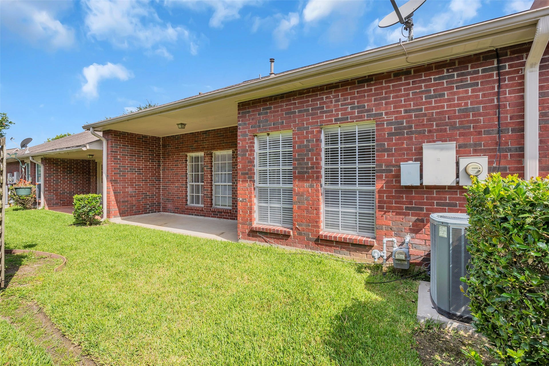 3310 Country Meadows Court, Pearland, TX 77584 Rear view of the home showcasing classic red brick exterior walls, highlighting a solid and timeless finish at the back of the property.