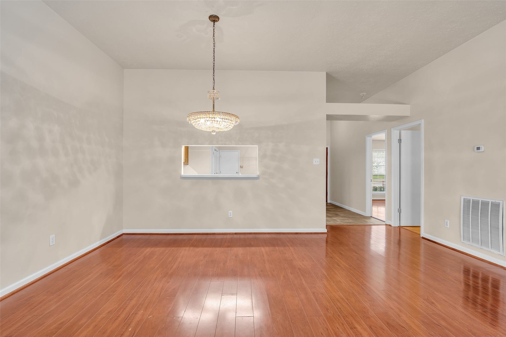3310 Country Meadows Court, Pearland, TX 77584 View of the dining area with continuous laminate flooring shared with the living room. Lighting features a crystal chandelier sourced from a Galveston estate.