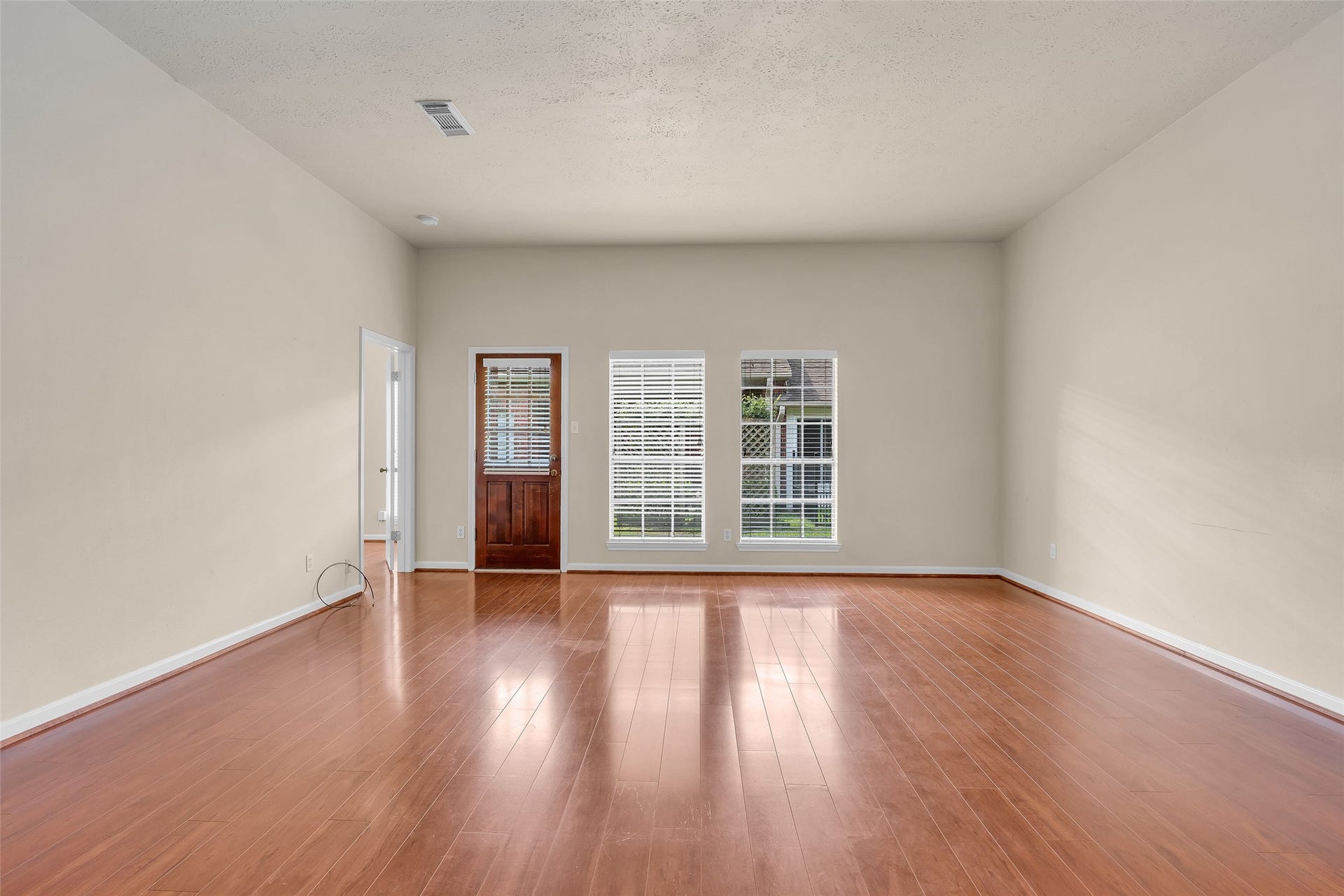 3310 Country Meadows Court, Pearland, TX 77584 A second door at the corner of the living room provides direct access to the primary bedroom, adding convenience and a well-connected layout to the main living space.