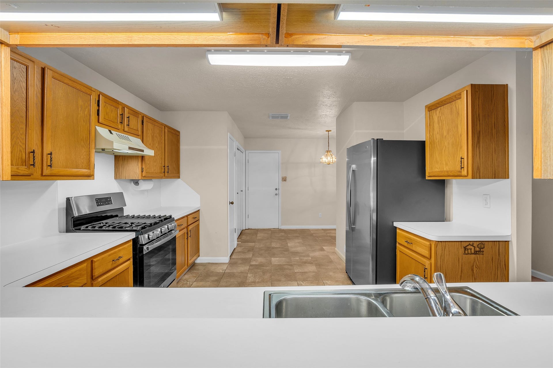 3310 Country Meadows Court, Pearland, TX 77584 Laminate countertops add a practical and easy-to-maintain surface to the kitchen, complementing its functional design.