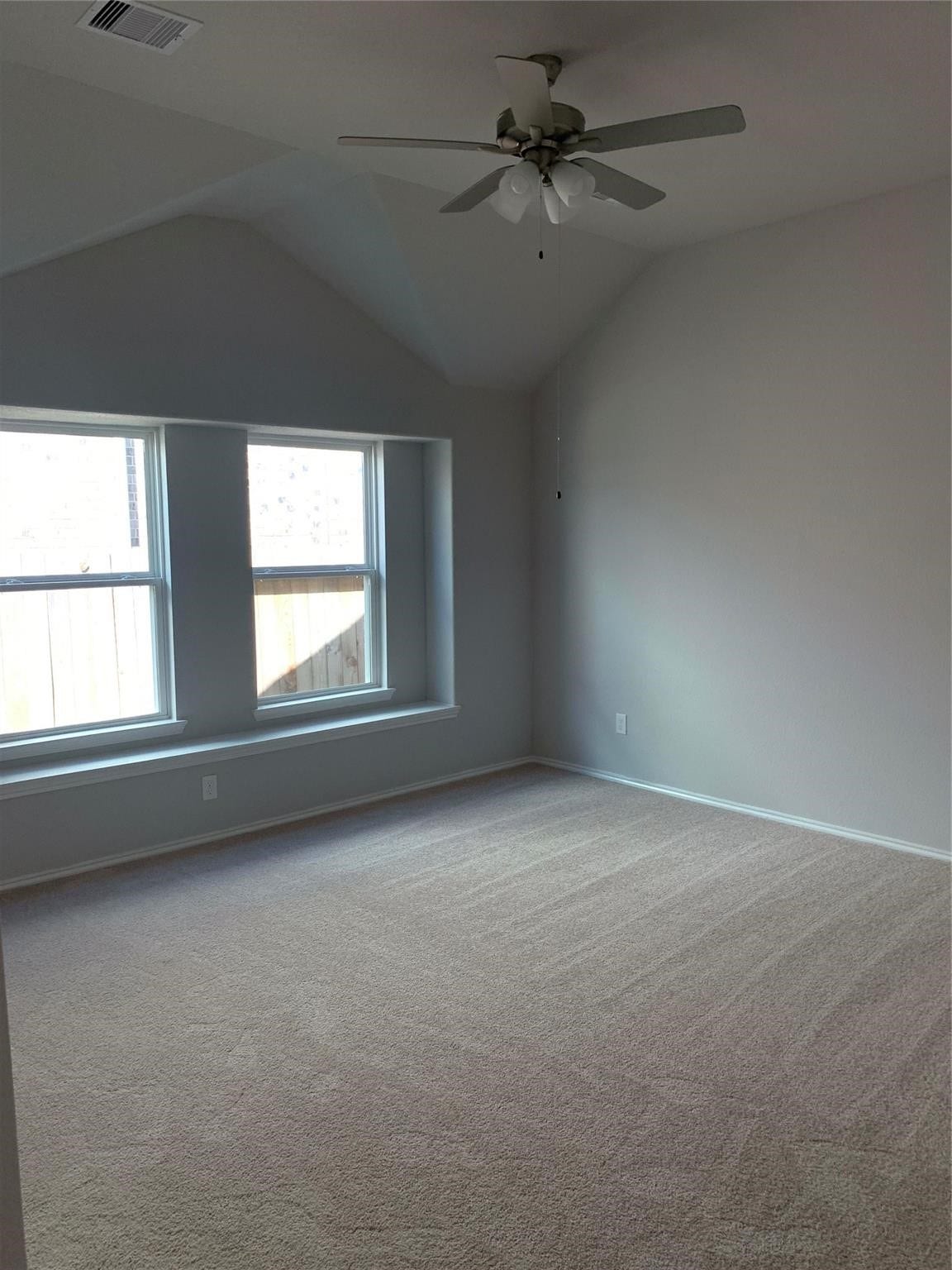 Primary Bedroom with high ceiling and fan
