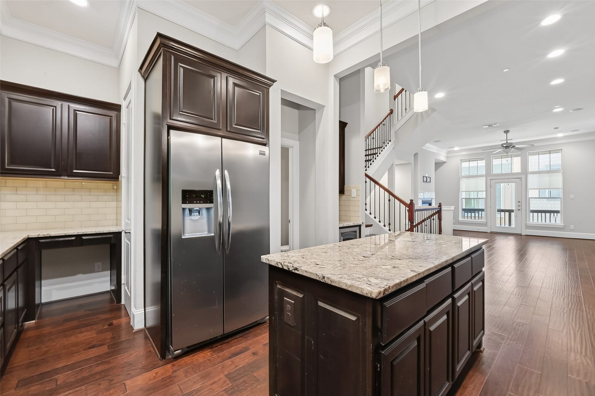 816 Yale Street, #C, Houston, TX 77007 The refrigerator is next to a built in desk space