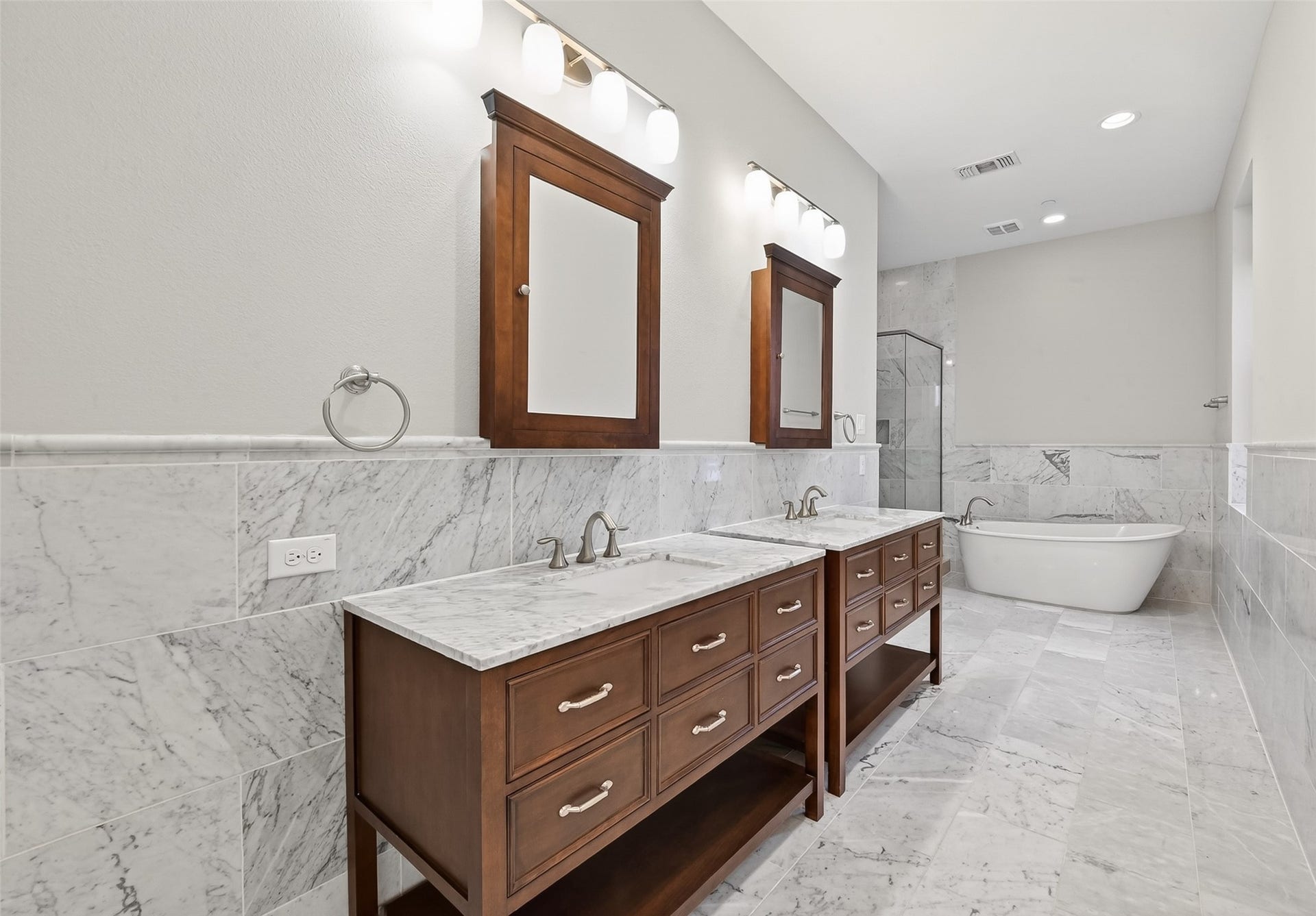 816 Yale Street, #C, Houston, TX 77007 This bathroom features a spacious layout with a double vanity, marble countertops, and elegant wood cabinetry.