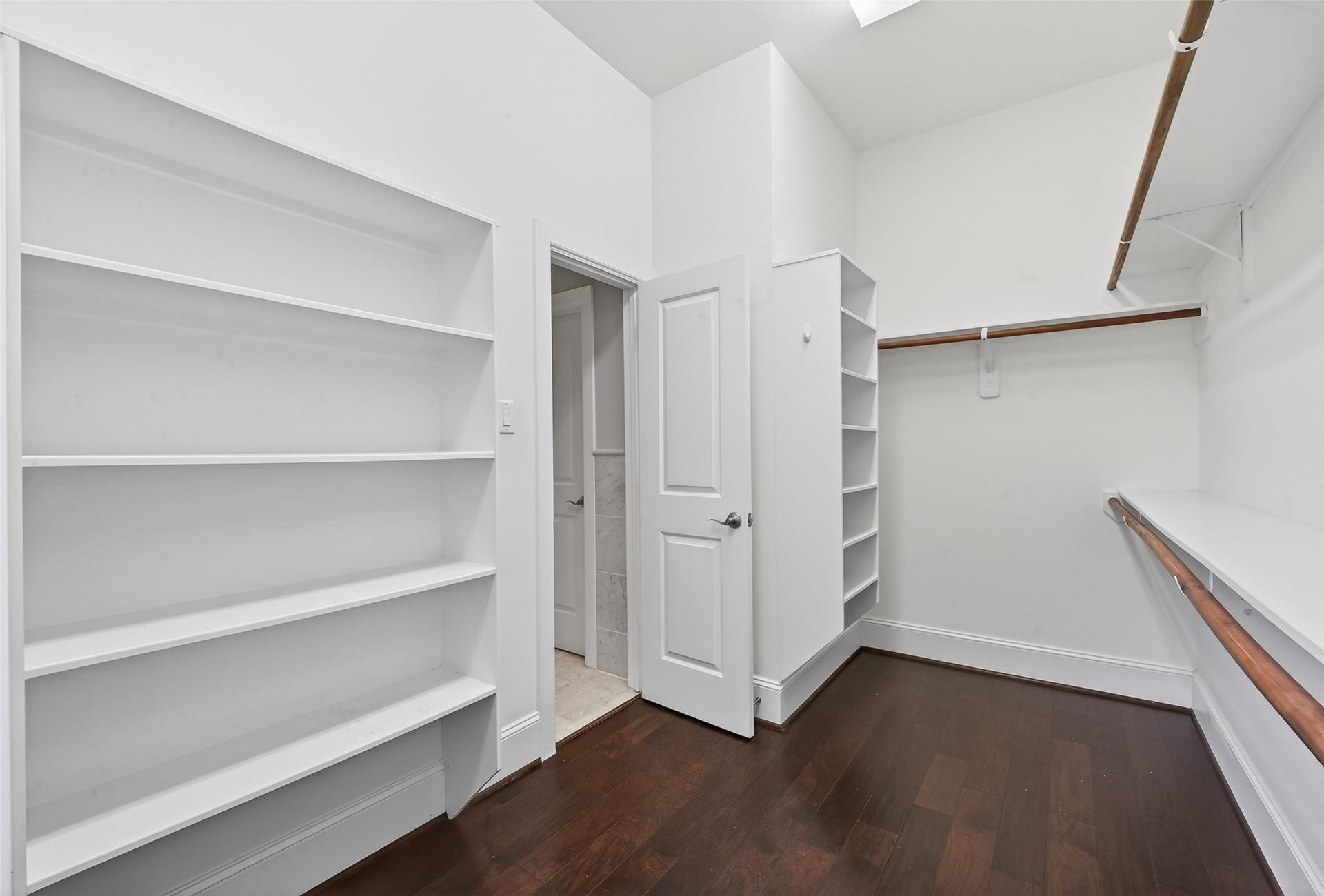 816 Yale Street, #C, Houston, TX 77007 Spacious walk-in closet with hardwood floors, built-in shelving, and ample hanging space.