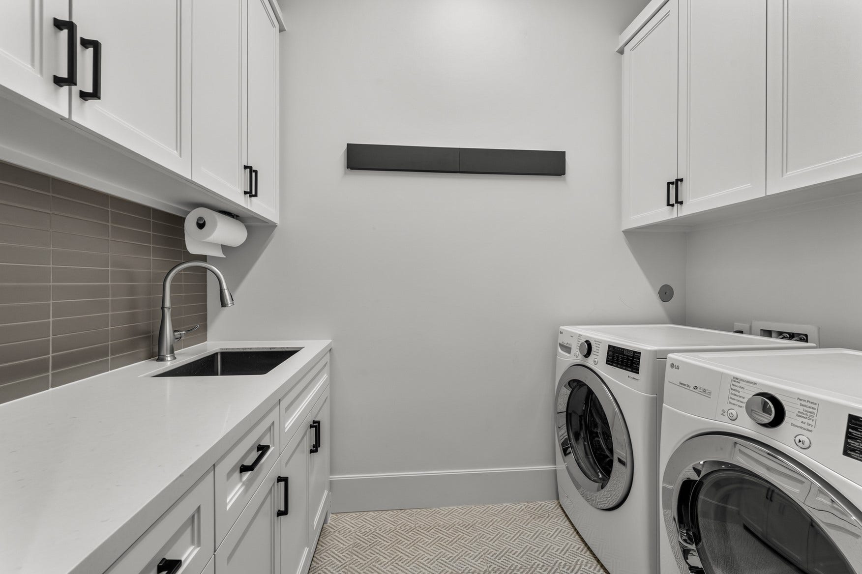 2328 Bissonnet Street, Houston, TX 77005 Laundry room includes fold out hanging bars from the wall, sink, and plenty of storage