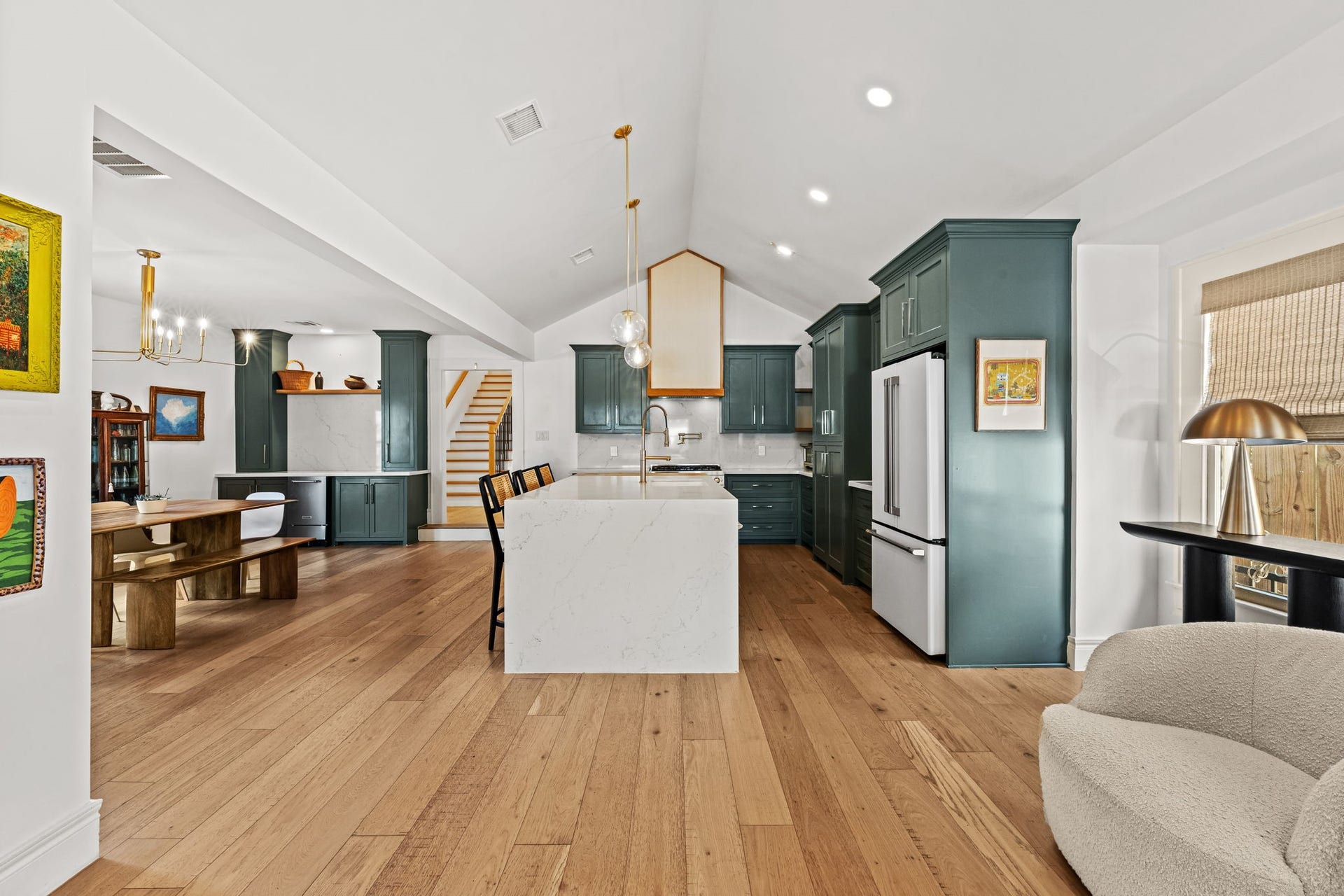Living room flows seamlessly to the kitchen with massive island