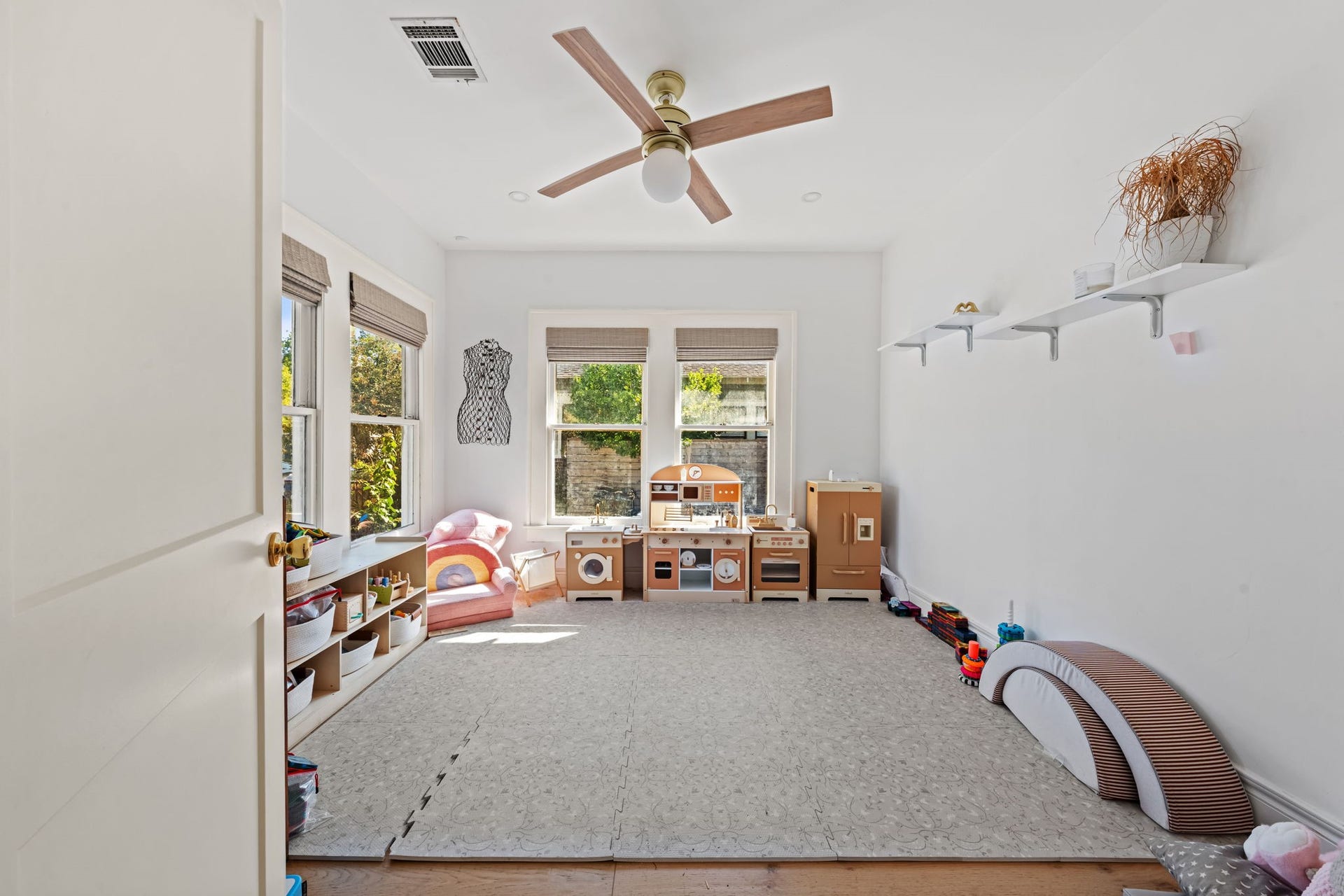Front room with tons of natural light. Can be used as a playroom or a home office.