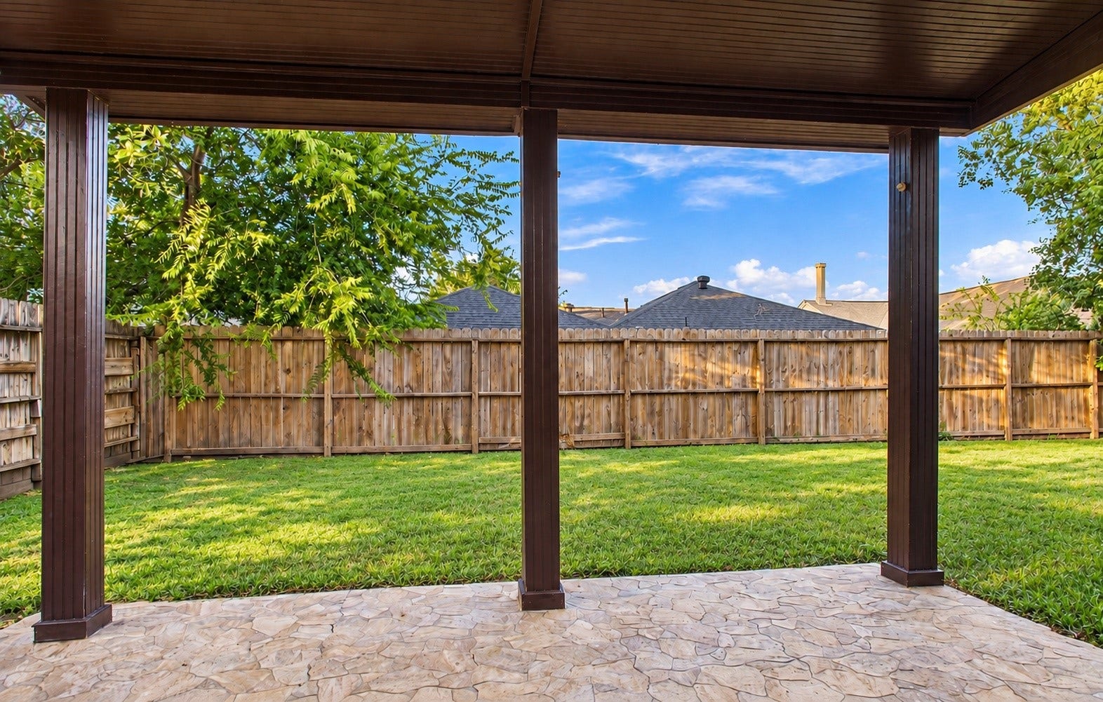 Another angle of the patio with the fully fenced backyard