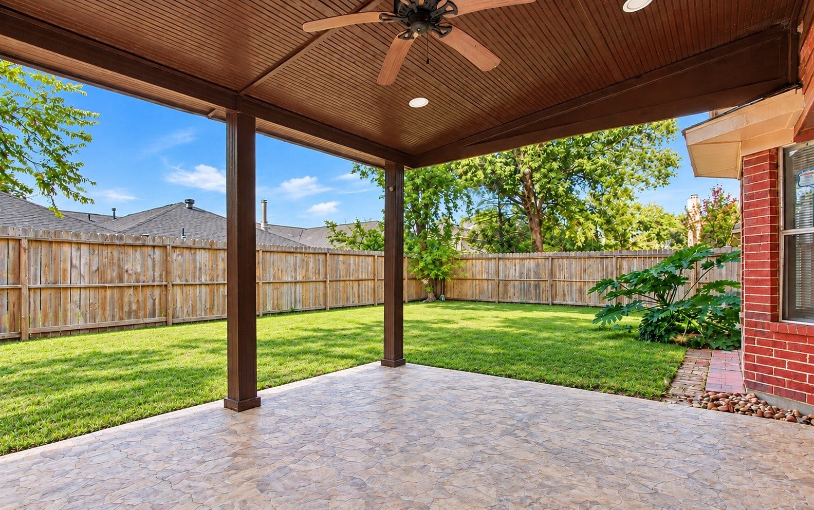 A view of the backyard from the covered patio