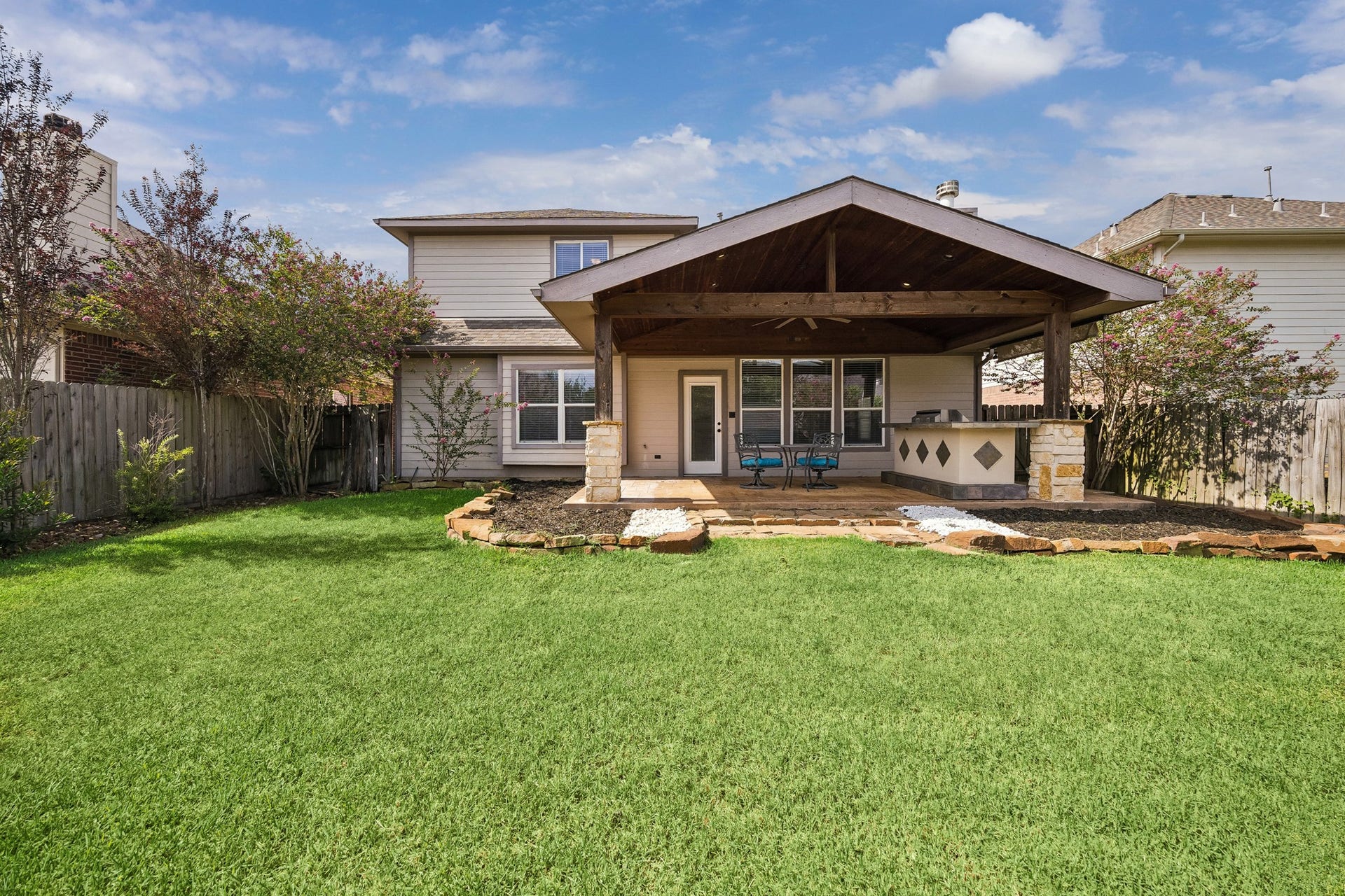30610 N Sulphur Creek Drive, Magnolia, TX 77355 Beautiful backyard with extended covered patio and outdoor kitchen.