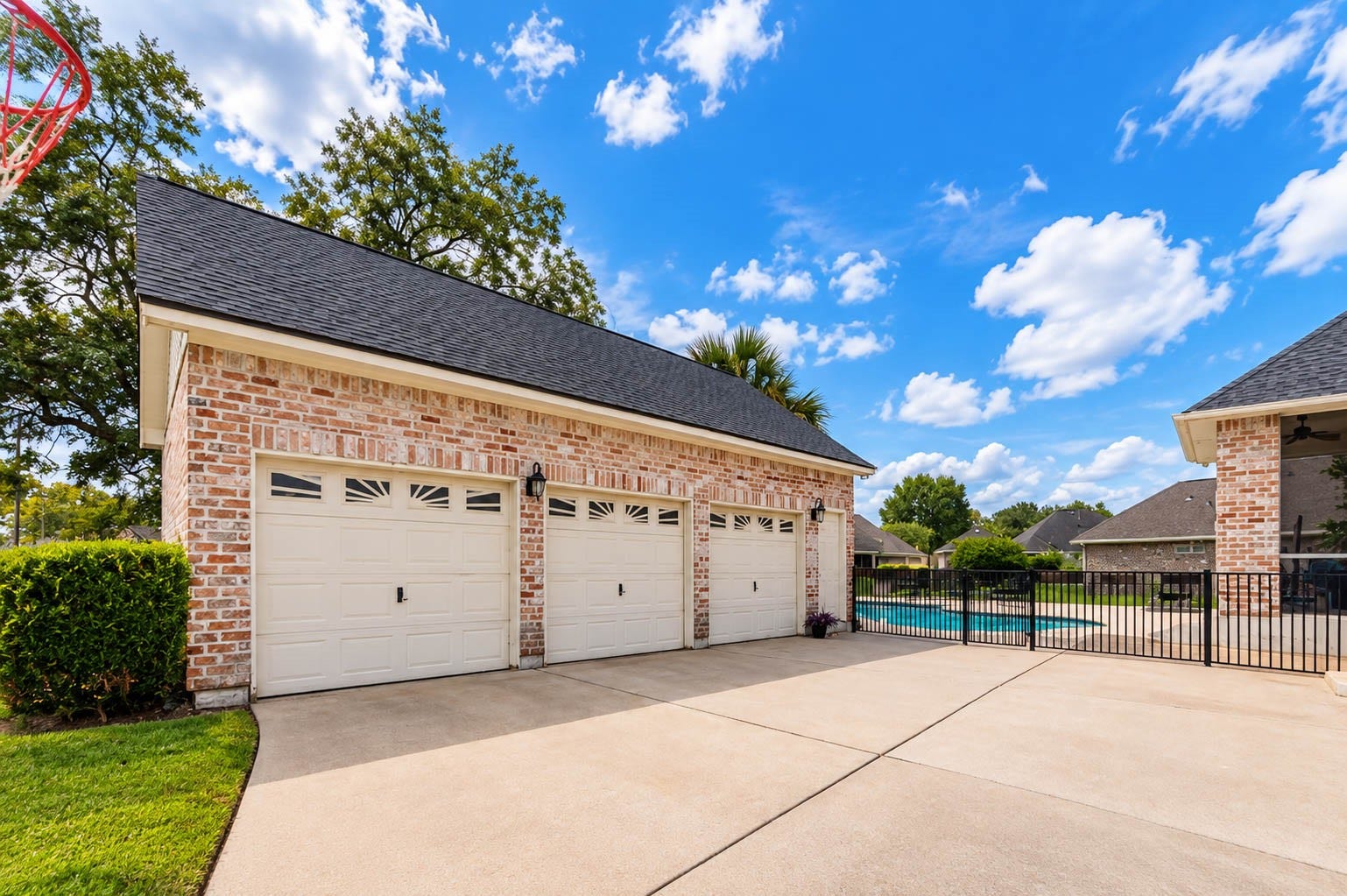 33103 Whickham Circle, Fulshear, TX 77441 The substantial detached three-car garage complements the architecture of the main residence with coordinating brickwork and rooflines. A wide driveway provides generous parking and convenient access to the garage and backyard areas.