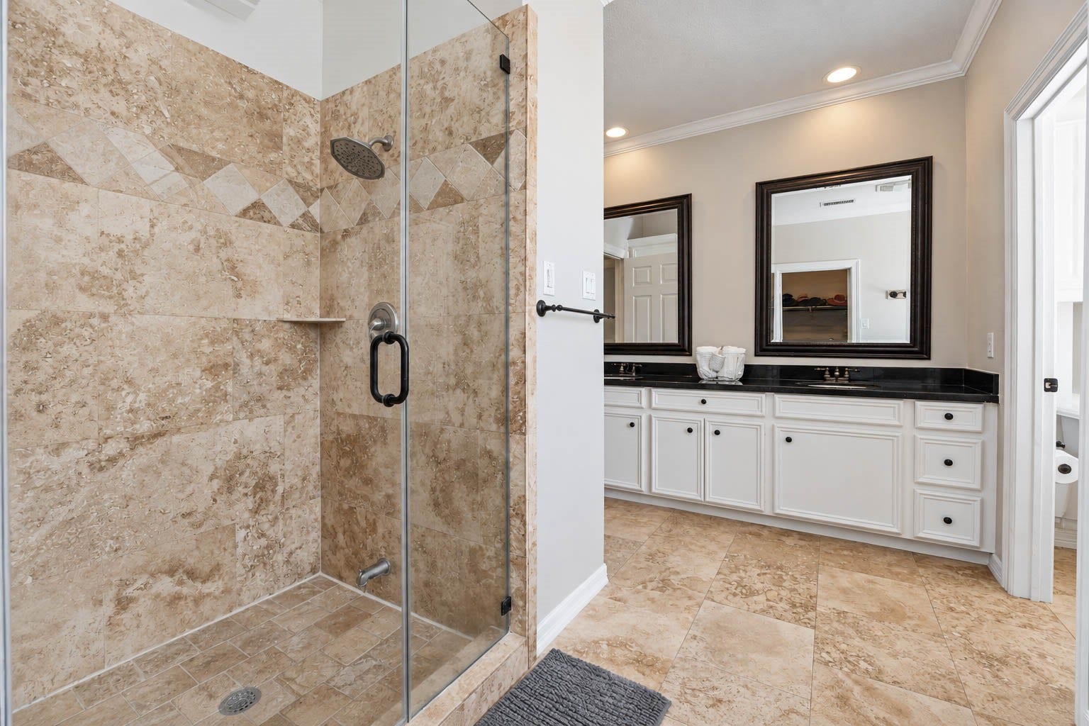 33103 Whickham Circle, Fulshear, TX 77441 An alternate view of the primary bath reveals a generously sized frameless glass-enclosed shower with an elegant tile surround, adding to the rooms spa-inspired appeal.